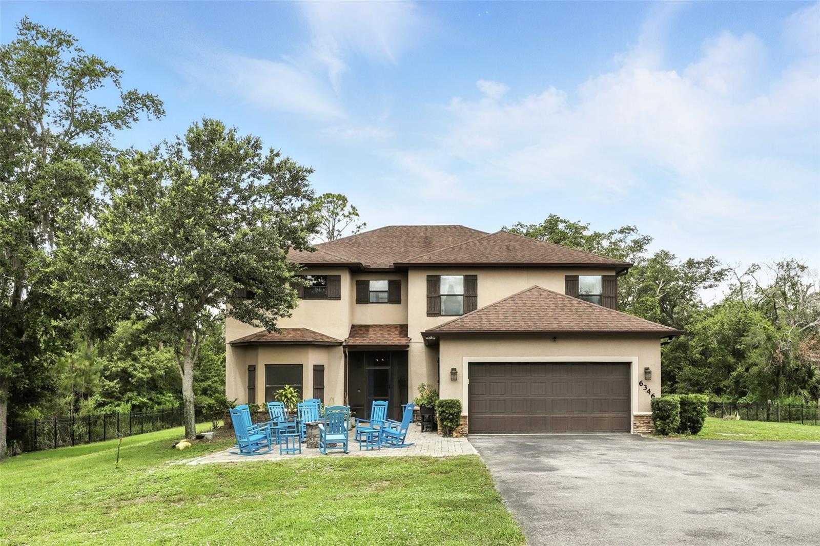 Don’t Miss Out on This Stunning Opportunity in Wedgefield Estates!
This is your chance to own a luxury retreat on a fully cleared, landscaped, and fenced acre of land. Perfectly blending space, privacy, and comfort, this property offers everything you’ve been looking for—without the restrictions of an HOA.
From the moment you arrive, you’ll appreciate the seclusion and peacefulness of this private sanctuary. The fully automated gates provide not only security but also the convenience of private access. With no neighbors on either side, your sense of privacy is truly unparalleled.
Relax and entertain in the inviting fire pit area, where you can enjoy beautiful views of the natural surroundings and clear, starry skies. Inside, the home welcomes you with a bright and open entryway, leading into a spacious and flexible layout. To one side, you’ll find a multipurpose room, versatile and ideal for a private office, playroom, or a quiet retreat.
The heart of the home is the open-concept living, dining, and kitchen space. With soaring 9' ceilings, custom woodwork throughout, and plenty of natural light, this area is designed for both comfort and style. The chef’s kitchen is a true highlight, featuring all-new stainless steel appliances, granite countertops, an island that seats six, and sleek custom cabinetry with beautiful tile backsplashes. For added convenience, built-in slide-out pantry shelves provide ample storage. Beyond that, the great room boasts elegant built-ins, crown molding, and chair rail details, offering the perfect setting for gatherings with friends and family. Large windows and sliding glass doors throughout the home allow tons of natural light into the space and present incredible views of the expansive yard. Meanwhile, a dining area at the back overlooks the backyard, making it ideal for hosting both dinner parties and casual meals.
The spacious Primary Bedroom Suite is tucked away for privacy and features an en-suite bath with dual vanities, an abundance of cabinet storage, a garden tub, and a separate shower.
Upstairs, you’ll find a generous bonus room that could serve as a movie room or additional living space, along with four large secondary bedrooms and two full bathrooms.
The outdoor living space is just as impressive, with a huge screened-in porch running the full width of the house and an open patio area with ample space for patio furniture and grilling. This is the perfect space to enjoy your morning coffee, soak up the Florida sun, entertain friends and family, or wind down after a long day, all while staying safe from mosquitoes.
Wedgefield Estates isn’t just about the home, it’s about the lifestyle. The 9,000-acre community includes a K-8 school, an 18-hole public golf course, and a large park with a dog park. For nature lovers, the Hal Scott Preserve is just steps away, offering hiking, biking, horseback riding, and fishing along the scenic Econlockhatchee River. With quick access to SR528, you’re only 15 minutes from the airport, Lake Nona’s vibrant dining and shopping scene, and 30 minutes to Florida’s beautiful Space Coast. Universal and Disney parks are just a 35-minute drive away, making this one of Orlando’s best-kept secrets.
Schedule your tour today—this one won’t last long!