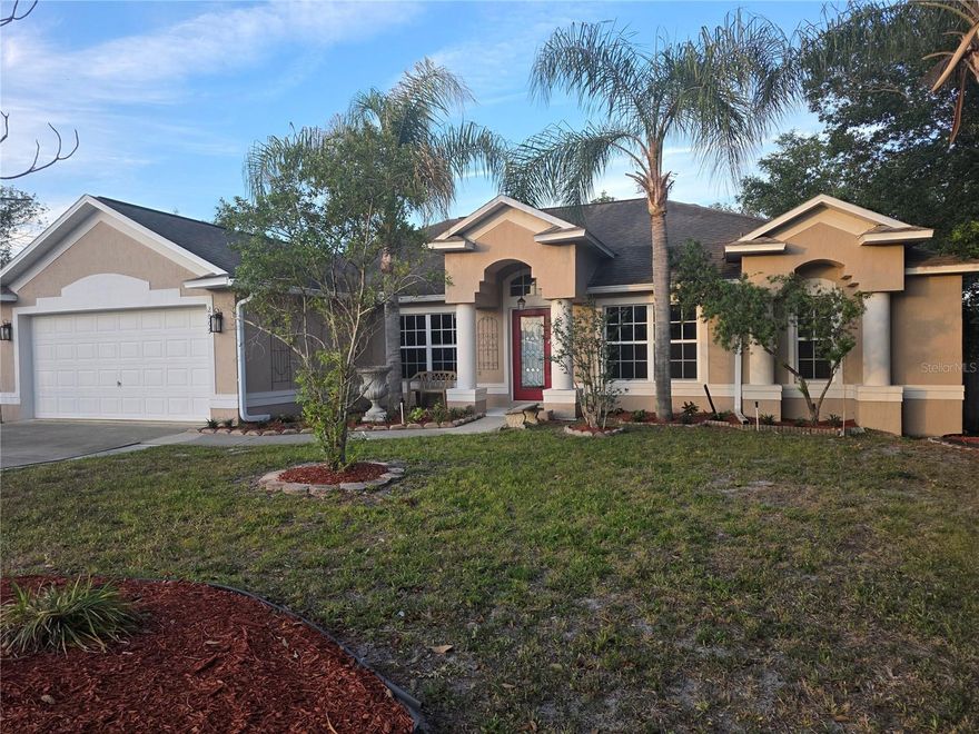 One or more photo(s) has been virtually staged. Beautifully updated Florida home featuring an open-concept layout with soaring vaulted ceilings, abundant natural light, and spacious living areas perfect for entertaining. The open kitchen offers warm wood cabinetry, stainless steel appliances, a large breakfast bar, decorative lighting, and generous counter space overlooking the main living areas.

The home includes multiple dining and gathering spaces, luxury vinyl plank flooring in the bedrooms, and a spacious primary suite with a beautifully renovated spa-style bath featuring a walk-in glass shower, soaking tub, and modern finishes. Additional bedrooms are bright and versatile with updated neutral tones throughout.

Enjoy indoor-outdoor living with a large screened Florida room and covered patio space ideal for relaxing or hosting guests while overlooking the private backyard with mature tropical landscaping. 

Conveniently located near shopping, dining, schools, and major roadways, this move-in ready home combines comfort, style, and Florida living at its best.