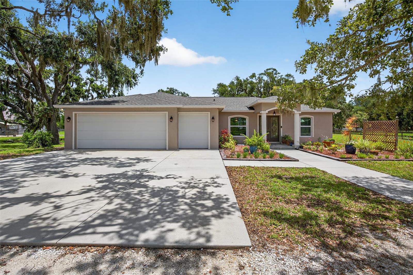 Welcome to your private retreat in the heart of Myakka Valley Ranches! This beautifully updated 4-bedroom, 3-bathroom, 3,024 sq. ft. pool home with a large den/office (easily convertible to a 5th bedroom) and an oversized 2.5-car garage offers the perfect blend of comfort, functionality, and rural charm. Set on a spacious 6.27 acres of fenced land with a 4-stall barn, it’s ideal for equestrian or animal lovers seeking room to roam.
Inside, you’ll find thoughtful upgrades throughout. The home features new vinyl plank flooring (2025), new hurricane-rated windows (2025), a new roof (2024), whole-house reverse osmosis system (2024) and the entire house was previously re-plumbed—offering modern peace of mind and exceptional water quality. Two new A/C units were installed in 2021, and the pool equipment was replaced in 2020.
The chef’s kitchen is as functional as it is beautiful, with solid wood cabinetry, pull-out shelving, a large island with prep sink, and two garbage disposals...perfect for the culinary enthusiast. The kitchen and covered patio are both plumbed for gas appliances, offering a seamless opportunity to build your dream outdoor kitchen.
The home also includes a gas fireplace, central vacuum system, security system, double laundry sink, double-insulated exterior doors and sliders, and lighted wood-shelved closets in every room for abundant storage. One of the dual master suites features wheelchair-width doorways, making it ideal for multigenerational or accessible living.
Step outside to your screened-in pool and spa, featuring automated color-changing lights, a gas heater, and a convenient pool bath. There’s even a dedicated patio closet for floats and pool equipment. The property’s 250-gallon propane tank was installed in 2025, and the home has never flooded.
Located in Myakka Valley Ranches, one of Sarasota’s most picturesque equestrian communities, the neighborhood is made up of approximately 280 homes, each situated on at least 5 acres, with winding roads and scenic nature trails perfect for walking, biking, or horseback riding.
Despite the peaceful, country setting, you're just 40 minutes from downtown Sarasota and a even shorter drive to Siesta Key’s award-winning beaches, with top-rated restaurants, shopping, and excellent public and private schools.
This exceptional property isn’t just a home—it’s a lifestyle. Come experience the space, serenity, and freedom of “the Valley.”