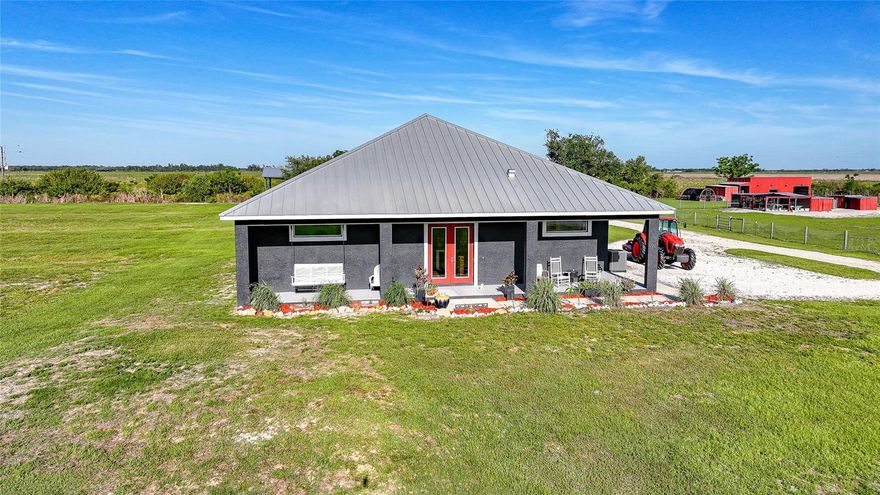 Welcome to the End Of The Road Farm. This is NOT a hobby farm. This is a turn-key, boots-on, coffee-on-the-porch, eggs-before-emails kind of property. Custom built in 2021 and lovingly owned by one owner, this 15-acre homestead is being sold mostly furnished, which means you can arrive with your suitcase and start living the life immediately. Let’s start outside, because the land is doing the absolute most. You’ve got a livestock barn with power, a shipping container with power, A/C, and two generators, a 10x20 greenhouse with irrigation, multiple chicken coops including a brooder, and a well house featuring a whole-farm reverse osmosis system plus an outdoor shower. There’s a massive 24x48 pole barn with RV hookup, the beginnings of a thoughtfully planned food forest with lemongrass, herbs, passion fruit, dragon fruit, and sea grape, a 40x80 irrigated garden, and so much open land it’s currently used as a hay field. Add in a 2-acre pond, underground power, power run throughout the property, and Starlink equipment already in place, and this farm is built for real living, not just dreaming. And yes. The animals come with it. Four cows and over 30 chickens are already home. Now let’s talk about the house, because it is absolutely the star of the show. The custom home features a gorgeous open floor plan with soaring ceilings that immediately make the space feel grand yet welcoming. The kitchen is a dream come true with hand-selected hickory cabinetry, granite countertops, and a classic farmhouse sink that fits the lifestyle perfectly. Three bedrooms and two bathrooms give everyone room to breathe, and the large utility room makes everyday life actually functional. The primary suite is a true retreat with two walk-in closets and a supersized bathroom featuring a walk-in shower with dual shower heads. It’s the kind of space that makes mornings slower and evenings quieter. Then there’s the backyard oasis. An inground heated pool, beautifully landscaped and surrounded by a large travertine pool deck, gives you a resort-level place to unwind after a long day on the land or to host unforgettable gatherings under the stars. This property isn’t just a home. It’s a vision already brought to life. If you’ve been waiting for a farm that actually works, one that’s beautiful, intentional, and ready on day one, this is it. (There is so much more to love about this property and a full marketing brochure is available upon request.)
