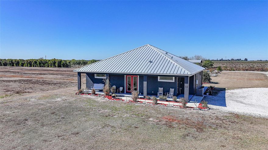 Welcome to the End Of The Road Farm. This is NOT a hobby farm. This is a turn-key, boots-on, coffee-on-the-porch, eggs-before-emails kind of property. Custom built in 2021 and lovingly owned by one owner, this 15-acre homestead is being sold mostly furnished, which means you can arrive with your suitcase and start living the life immediately. Let’s start outside, because the land is doing the absolute most. You’ve got a livestock barn with power, a shipping container with power, A/C, and two generators, a 10x20 greenhouse with irrigation, multiple chicken coops including a brooder, and a well house featuring a whole-farm reverse osmosis system plus an outdoor shower. There’s a massive 24x48 pole barn with RV hookup, the beginnings of a thoughtfully planned food forest with lemongrass, herbs, passion fruit, dragon fruit, and sea grape, a 40x80 irrigated garden, and so much open land it’s currently used as a hay field. Add in a 2-acre pond, underground power, power run throughout the property, and Starlink equipment already in place, and this farm is built for real living, not just dreaming. And yes. The animals come with it. Four cows and over 30 chickens are already home. Now let’s talk about the house, because it is absolutely the star of the show. The custom home features a gorgeous open floor plan with soaring ceilings that immediately make the space feel grand yet welcoming. The kitchen is a dream come true with hand-selected hickory cabinetry, granite countertops, and a classic farmhouse sink that fits the lifestyle perfectly. Three bedrooms and two bathrooms give everyone room to breathe, and the large utility room makes everyday life actually functional. The primary suite is a true retreat with two walk-in closets and a supersized bathroom featuring a walk-in shower with dual shower heads. It’s the kind of space that makes mornings slower and evenings quieter. Then there’s the backyard oasis. An inground heated pool, beautifully landscaped and surrounded by a large travertine pool deck, gives you a resort-level place to unwind after a long day on the land or to host unforgettable gatherings under the stars. This property isn’t just a home. It’s a vision already brought to life. If you’ve been waiting for a farm that actually works, one that’s beautiful, intentional, and ready on day one, this is it. (There is so much more to love about this property and a full marketing brochure is available upon request.)