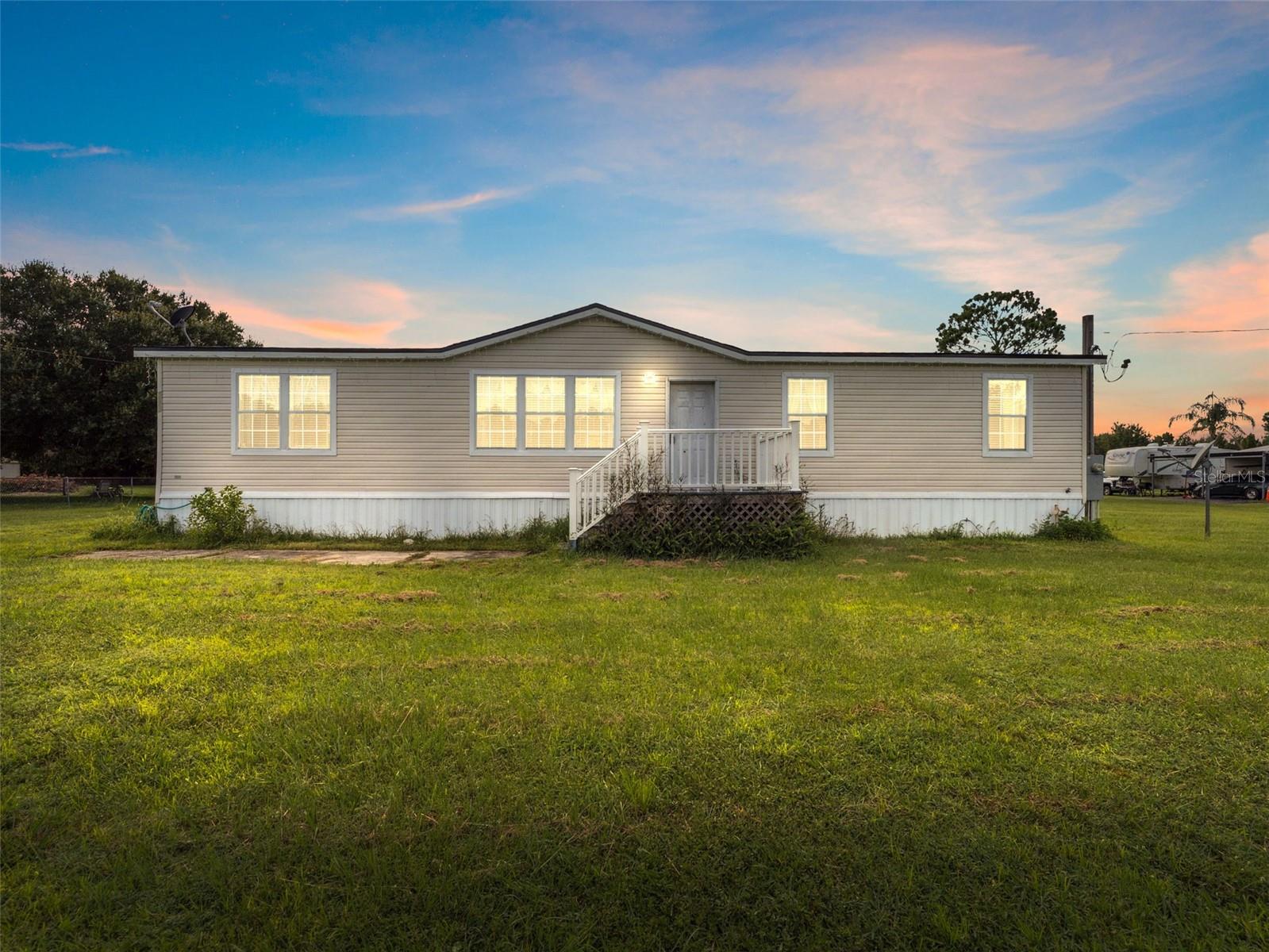 Escape to the peaceful countryside of Lake Wales with this beautiful home! Offering 3 spacious bedrooms and 2 bathrooms, POOL home is ideally located near downtown, Bok Tower, shopping, dining, and more. Set on 1.03 acres, the mobile home includes a carport that accommodates two vehicles and extra storage. The kitchen is equipped with stainless steel appliances and a breakfast/island bar that opens to the cozy living room. Each bedroom offers plenty of room. Don’t miss your chance to own this charming home—schedule a tour today!