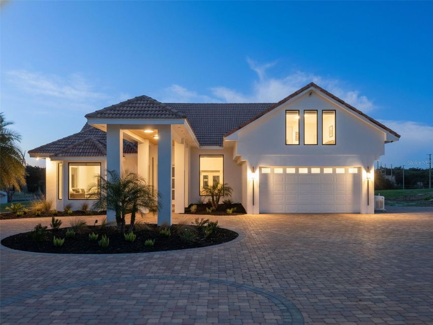 One or more photo(s) has been virtually staged. Discover the perfect blend of modern luxury and serene country living in this stunningly remodeled pool home. Situated on nearly two acres of lush land in Groveland, (with 5+ more acres available to purchase next door) this expansive estate offers over 3,800 square feet of meticulously designed living space, featuring 5 bedrooms and 3 full bathrooms. The heart of the home is a bright, open-concept kitchen and living area, showcasing polished oversized tile floors and abundant natural light. The kitchen is a showstopper, featuring sleek white cabinetry, a large central island, and modern pendant lighting. Retreat to the primary suite, which includes a spa-like bathroom with a massive walk-in shower, a contemporary soaking tub, and a double vanity with an integrated LED mirror. Exceptional flexibility defines this floor plan, which includes an additional flex room and a dedicated media room—perfect for a home office, gym, or theater. Large sliding glass doors lead you to a private outdoor oasis, where a sparkling pool and integrated spa await. The sprawling, screened-in patio provides the ideal backdrop for entertaining while enjoying peaceful views of the expansive backyard and distant lake. With a spacious circular driveway and no HOA, this property offers the freedom and privacy you’ve been searching for. Come experience the quality craftsmanship and thoughtful upgrades that make this house a true retreat. (kitchen countertops & appliances virtually staged - buyer can pick out finishes- samples of counter tops inside the home)