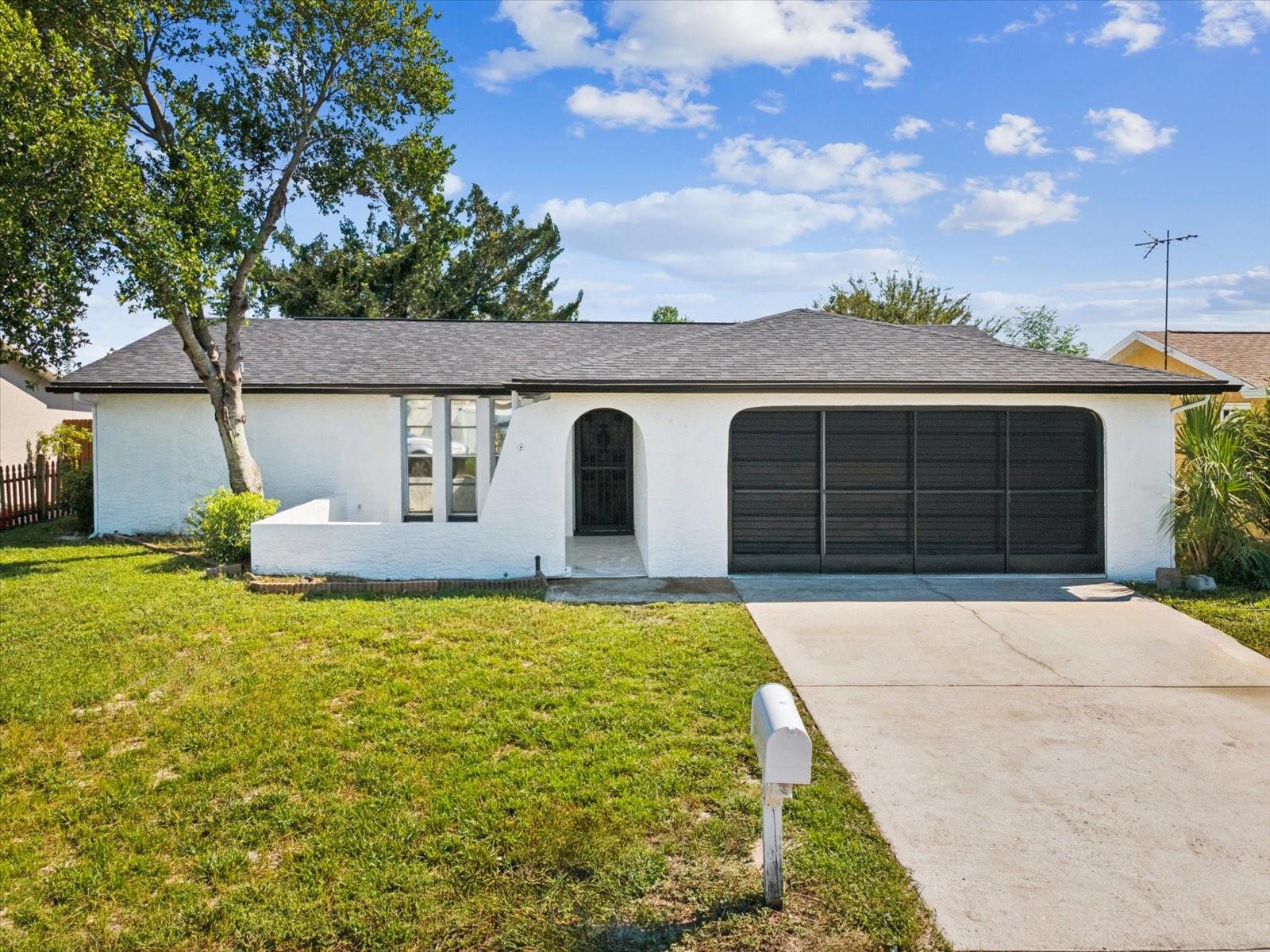 Welcome to this beautifully updated Port Richey home featuring modern finishes and a functional layout. Improvement highlights: freshly painted interior and exterior, improved lighting (inside and out), plumbing fixtures, luxury vinyl flooring & baseboards throughout, renovated bathrooms & improved kitchen! Enter into this light, bright and spacious Living Room with ceiling fan! The updated kitchen offers light cabinetry, butcher block-style counters, subway tile backsplash, and a wine rack feature, opening seamlessly to the family room, ideal for gatherings or relaxing evenings. The primary bedroom includes an ensuite bath with a walk-in shower, seamless glass door, solid-surface vanity, stylish tile, and updated fixtures. The second bedroom features a walk-in closet and private access to the hall bath, with a walk-in shower, seamless glass door, solid-surface vanity, stylish tile, and updated fixtures. Additional recent updates include a new roof and an updated electrical panel in 2024. An oversized two-car garage provides convenience, while the spacious fenced backyard offers plenty of room to relax, garden, or play. The shed is operational and conveys as-is. With quick access to the Suncoast Parkway and just 35 minutes to Tampa International Airport, this location combines comfort and convenience, close to shopping, dining, schools, parks, and the Gulf beaches.