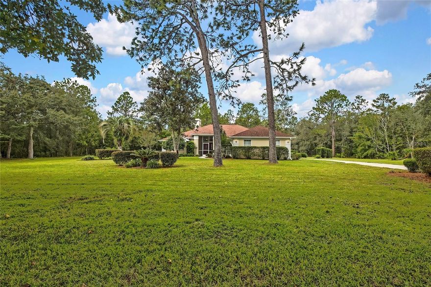 One or more photo(s) has been virtually staged. HONEY STOP THE CAR!!! TALK ABOUT BANG FOR YOUR BUCK, Huge Lot, Mature Landscaping, Pool, Spa, Outdoor Kitchen, Fireplace, Fenced. THIS ONE REALLY CHECKS THE BOXES and is in a highly sought after Pine Ridge. As you pull up, you’ll notice the curb appeal right away. A picturesque Mature landscape and Majestic Oak trees that line the front of the property. The house is set back in a slightly elevated 1.20-acre lot, providing ample room for recreational vehicles and equipment. Enter the home through a front door to a vast view through the living room strait out the 8-foot glass pocket sliders that take up most of the wall allowing not only a lot of natural light but when open, creating an added 300+ square feet of entertainment space. Enjoy your own little oasis in the 30 x 14 covered lanai complete with outdoor kitchen that looks over the huge pool and spa freshly sealed and painted with cool deck. The home also has an open floor plan with soaring 10-foot ceilings and crown molding throughout. The layout features a separate dining area that leads to an inviting kitchen with new range & dishwasher and a breakfast nook complete with a bay window and sliders that lead out to the covered pool area. You will also love open concept breakfast bar that looks over the living room. The living room features fireplace with built-in bookshelves on each side perfect for curling up with a fire and good book in those cooler months of year. The split floor plan has the primary bedroom taking up the entire south side of the house with a huge 20x12 bedroom space featuring a trey ceiling and sliding glass doors that also lead out to the pool. This will lead to a large walk-in closet and master bath featuring double sinks, linen closet, sperate water closet with walk in shower and in the center, to pamper yourself is a jetted garden tub with steps and a shelf for a little extra “me” time. On the north side of the house is a hall that will lead you to 2 additional generous size bedrooms and a full bath which doubles a pool bath with a door that also leads out to the pool. The indoor laundry is complete with cabinets and a built-in folding table for your convenience. As if that were not enough, you are going to love the oversized 700 sq/ft 2 car garage with tons of extra space for a work bench and more. The sellers have strategically priced the home so that any improvements wanted or needed will only add equity and value to this already wonderful home. Though the property is being sold as-is and the sellers are not in the position to do repairs, they may be willing at the right price to negotiate some creative assistance such as a rate buy down, closing cost credit etc."  Home Warranty is also being provided by the seller(s). The Pine Ridge community boasts miles of acreage and is a unique upscale development with diverse styles and layout. This beautiful community has amazing amenities such as horseback and walking trails, The complex has lighted tennis and pickleball courts, shuffleboard, a dog park, a radio-controlled plane flying field with airstrip and shade pavilion, a state-of-the-art playground with shade cover, swings and a gazebo. Clubs host weekly games, monthly bingo night, Equestrian Association, Poker, Sewing, Reading, Quilting, Fishing, Airplane, Bowling, Tennis, Bunco, Mahjong, Hand & Foot and Shooters Clubs and much more. Schedule your showing today.