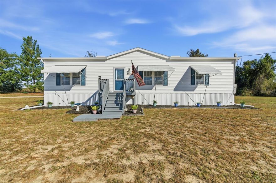 If you are tired of the high costs of single-family homes, consider this 2021 manufactured home built by Jacobsen, located in a non-flood zone on a 1.2-acre lot. This property has all of the ammenities of a single family home at half the cost. There are no HOA or CDD fees, and there was no damage from the 2024 hurricanes. This home is meticulously maintained…and has an open concept, high ceilings, luxury vinyl throughout, and plenty of storage; each of the three bedrooms has its own walk-in closet. There is plenty of room to host family gatherings inside and out. There is a large wooden deck (12X20) located on the rear of the property, which is ideal for socializing and cook-outs. As added security, the front windows are protected by hurricane awnings. Additionally, all of the stainless steel appliances are less than 3 years old. Included in the purchase price is a massive 12X24 shed, which has electricity.
