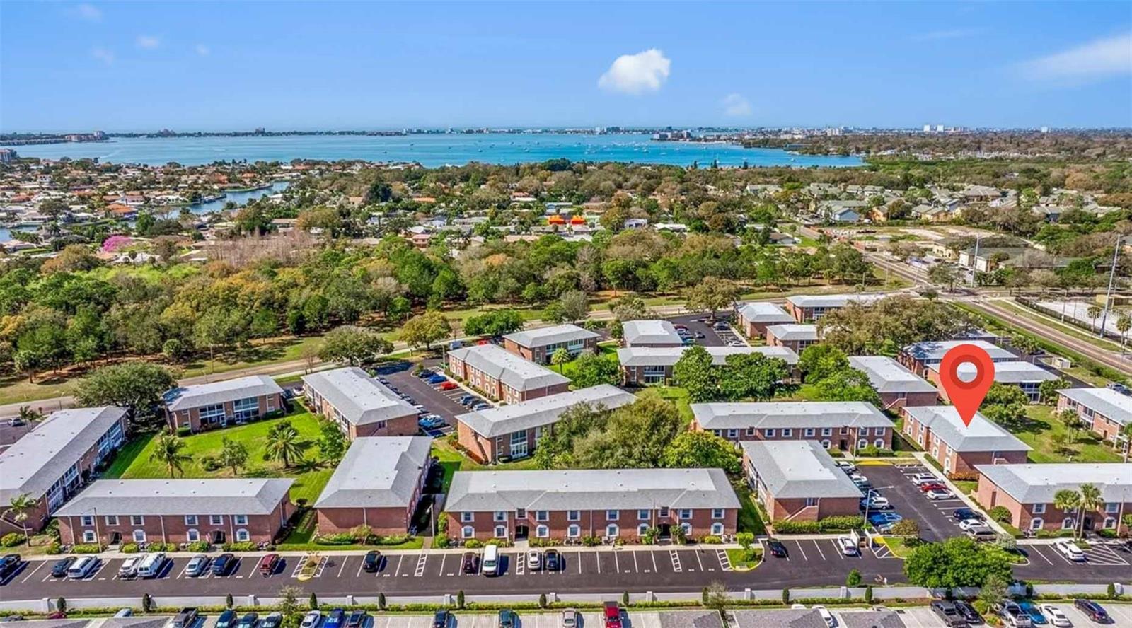 Welcome to Patriot Square and this beautifully maintained FIRST FLOOR 3 bedroom/2 bath unit is in a 55+ community located in the Skyway Marina District which is seeing a huge amount of growth and luxury development. There is nothing you have to do in this condo as it has been totally remodeled for you!  This freshly painted condo offers a beautiful new kitchen with stainless steel appliances, quartz counters and front-loading washer and dryer.  The floor plan allows everyone to enjoy a conversation while enjoying the beautiful garden view through the sliding glass doors that lead to the screened in Lanai. The spacious primary bedroom offers a large walk-in closet and a beautiful, tiled shower in the updated en-suite bathroom. The oversized second bedroom has lots of closet space and the second bathroom has also been updated with a tub/shower combination. The 3rd bedroom has access to the Lanai through the sliding glass doors but could also make a great office or den. New electrical panel, impact windows, and newer HVAC. Patriot Square is a 16-acre retreat featuring two pools (one heated), tennis/pickleball courts, shuffleboard, sauna and a clubhouse with many active social events. Located with easy access to restaurants, shopping, DTSP, GULFPORT, and museums. You are a mere 6 minutes away our bests GULF BEACHES like Pass A Grille, Fort Desoto Beach, and St Pete Beach.