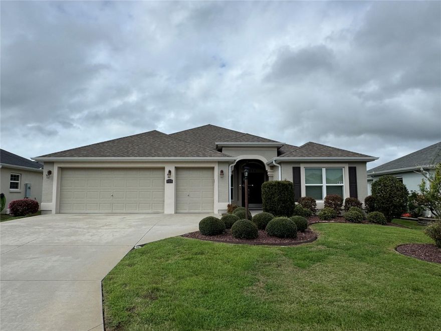 Beautiful Begonia model three-bedroom, two-bath home located in a mature neighborhood close to Brownwood Paddock Square. The master suite features tray ceilings and his-and-her walk-in closets. Spacious kitchen with an adjoining dining area. The kitchen and bathrooms include attractive Formica countertops, a tumbled marble backsplash, and Whirlpool appliances, along with a Samsung washer and dryer. Spacious laundry room featuring a utility sink and overhead cabinetry. Enjoy the convenience of pocket doors separating the guest bedrooms and bath for added privacy. The home features carpet in the bedrooms, dining room, and living room, with tile flooring throughout the remaining areas. Relax on the screened lanai overlooking beautifully landscaped grounds. Additional highlights include a two-car garage plus a golf cart garage. Located near shopping, dining, entertainment, recreation centers, fitness centers, golf courses, hospitals, and local doctors—everything The Villages lifestyle has to present. Optional furniture package available.