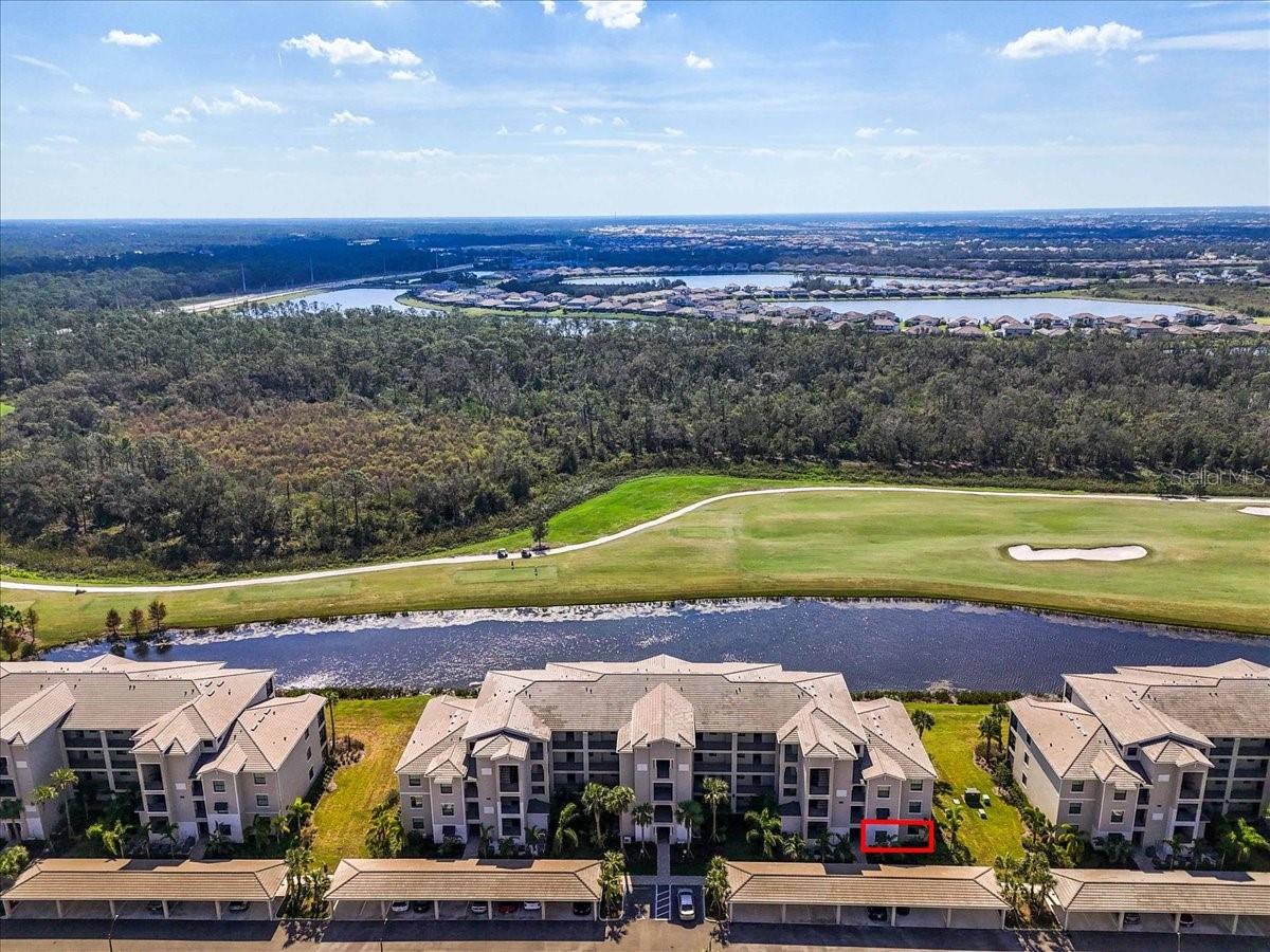 GROUND FLOOR, END UNIT, 3-bedroom, 2 bathroom condominium with golf membership in an amenity-rich community! NO CARPET. Beautifully designed and perfectly situated on the ground floor, offering easy access. Open floor plan filled with natural light, featuring a spacious living area that seamlessly flows into a modern kitchen equipped with stainless steel appliances and ample quartz counter space. The center island is a great place to have breakfast or a snack. Off the kitchen is a generous dining area. The primary suite boasts a private bathroom and a dual closets and is at the back of the home with water views, providing a tranquil retreat at the end of the day. The covered and screened lanai is next to the primary suite, off of the living area. It is a great place to enjoy your morning coffee or unwind in the evening with beautiful water and golf views. The split floor plan places the two additional bedrooms at the front of the unit, with one of the bedrooms connecting to the other full bath. Guests are able to access that bathroom from the hallway as well. The third bedrooms makes a great guest space, home office, or a hobby space. The unit comes with an outdoor storage closet as well as a reserved, covered parking space. Plenty of guest parking available. This property includes coveted golf membership, allowing you to enjoy the pristine greens of the community’s Arnold Palmer Championship 36-hole golf course. Beyond your front door, indulge in a wealth of amenities, including a grand clubhouse with beach entry lagoon pool, fitness center, clay tennis courts, casual poolside dining, full service spa, and so much more. Feel safe and secure with guarded gate access. Convenient access to everything Lakewood Ranch has to offer. Close to I-75, Waterside, UTC, top rated schools, shopping and dining. Not in a flood or evacuation zone but still close enough to all your favorite beaches. Within 22 miles of Siesta Key, Lido Key, and Anna Maria Island.