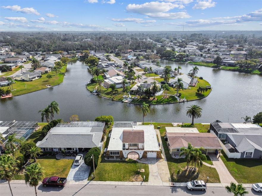 Located in the desirable Beacon Square community, and including a free one-year membership to the Beacon Square Civic Association, this lakefront home offers the perfect blend of relaxation and adventure! Bring your kayak and fishing pole! With direct canal access, you can enjoy Florida waterfront living right from your backyard. This beautifully updated 2-bedroom, 2-bath home features a 1-car garage, a bright open floor plan, and stylish tile flooring throughout. The modern kitchen flows seamlessly into spacious living areas, creating an inviting space for everyday living or entertaining. Step outside to your screened-in pool overlooking the water, the ideal spot to unwind and take in the serene views. The large backyard offers even more room to relax, host gatherings, or soak up the Florida sunshine. Conveniently located near shopping, dining, parks, and stunning Gulf Coast beaches, with easy access to major highways, this home combines comfort, charm, and convenience. A rare rental opportunity you won’t want to miss!