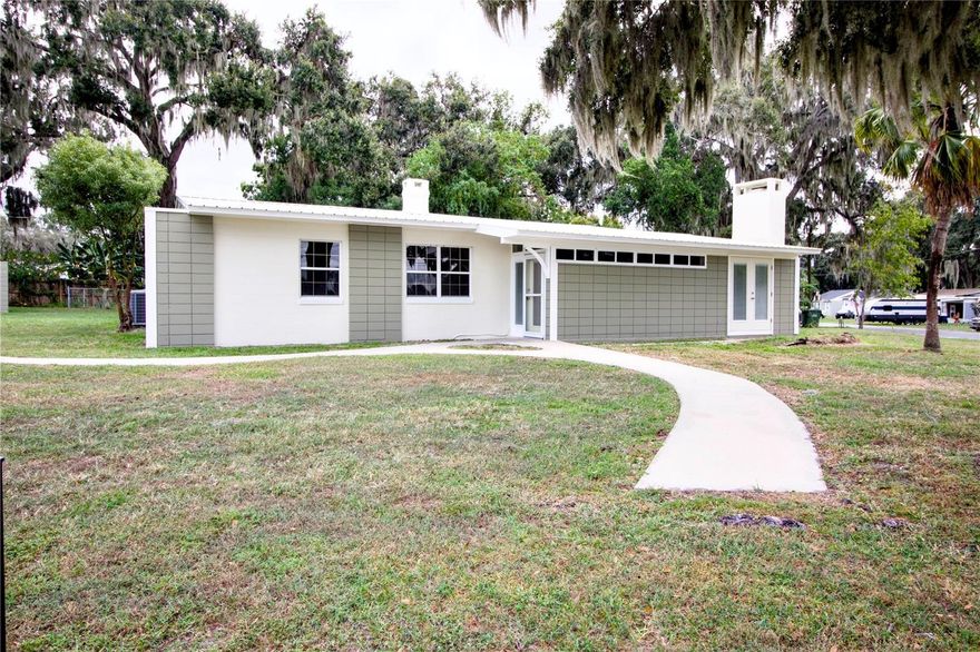 Welcome to this beautifully renovated and spacious family home located in a desirable Leesburg neighborhood! This charming 2,108 sq ft home, originally built in 1953, has been completely updated for a perfect blend of modern amenities and classic appeal. Featuring 4–5 bedrooms and 2 full baths, it provides ample room for comfortable living and entertaining.
The inviting living room offers a cozy fireplace and large double doors overlooking the front yard. The modern kitchen includes new stainless steel appliances, updated countertops, and plenty of cabinet space with an extended area ideal for a coffee bar or buffet. The spacious master suite features a sitting area or office space, an en-suite bath, and direct access to the laundry room and backyard. Three additional bedrooms provide flexibility for family, guests, or a home office, and both bathrooms have been fully remodeled with stylish fixtures.
Outside, enjoy a large corner lot with a manicured lawn, expansive backyard, and side yard perfect for pets and outdoor gatherings. A covered porch and adjacent concrete patio create an excellent space for dining or entertaining. The property also includes a 10’x17’ powered workshop with double doors and a concrete floor—ideal for projects, storage, or a riding mower. A mature oak tree provides shade to the front yard and enhances the home’s curb appeal.
Conveniently located near downtown Leesburg, Lake Harris, and several parks, this home is close to schools, restaurants, and shopping. Don’t miss this opportunity to make 1114 Oak Drive your new home!