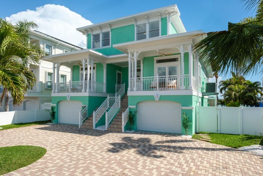 SURROUND YOURSELF IN PARADISE AT THIS ONE-OF-A-KIND KEY WEST–STYLE WATERFRONT RETREAT. Wake up to breathtaking views of Boca Ciega Bay, enjoy deep boating water with unobstructed access to the Gulf of Mexico, and take a short stroll to the sugar-white sands of St. Pete Beach. Custom built in 2004 to a 14’ elevation with superior construction quality, this tropical residence just got a BRAND-NEW RENOVATION throughout the entire home, and you will love it! 

Designed for both coastal elegance and entertainment, this home features 4 spacious en-suite bedrooms, 5.5 bathrooms, a stylish sitting room/library, an elevator and a bonus media/game space spanning over 3,800 square feet of refined modern living. There’s plenty of space for cars too with 2 garages holding 4 cars total plus room for toys. Add an additional 1,200 square feet of covered balconies and patios, and you’ll enjoy more than 5,000 square feet of covered living space—ideal for embracing the Florida lifestyle year-round.

The bright, open-concept interior showcases 9’ ceilings, expansive floor-to-ceiling windows and sliders, and a seamless indoor-outdoor flow that floods the home with natural light, spectacular water views and an unbeatable bay breeze. The chef’s kitchen is a focal point showcasing a new remodel with stunning solid white cabinetry, striking Quartz countertops, new S.S. appliances with a 6-burner stove and oven/microwave combo, center prep island, and a generous high-top bar—perfect for hosting friends, family and events. 

So many amazing new updates have been made including luxury vinyl flooring throughout, custom accent walls, redesigned modern fireplace, new LED lighting and fixtures, all updated bathrooms, new interior paint and much more. Thoughtful custom details are found throughout, including coffered ceilings, crown molding, plantation shutters, custom wallpaper accents and elevator access to all levels. 

Your new primary suite received a luxurious spa-like remodel too! As you enter through French doors, you can’t help but notice the beautiful Herringbone pattern luxury vinyl floors and gorgeous water views. The bathroom was completely redesigned with a stand-alone tub and large walk-in shower. The walk-in closet is spacious and has built-in shelving. Step out on the private balcony for perfect sunset evenings. Each guest bedroom is a spacious, private en-suite retreat with updated baths and water views. 

Step outside to your own resort-style waterfront oasis. Enjoy a new Trex dock with a 30,000-pound boat lift, providing effortless access to the Gulf—perfect for boating enthusiasts. Outdoor living is elevated with expansive balconies, an outdoor kitchen, built-in fire pit, heated pool and spa, approximately 750 square feet of turfed space, and ample room for lounging, dining, and entertaining against the spectacular bay backdrop.

This exceptional home delivers the ultimate coastal lifestyle—just a short walk to the beach, restaurants, shops, and entertainment. Conveniently located only 15 minutes to downtown St. Petersburg and 30 minutes to Tampa International Airport, this is truly the best of both luxury and location. This is more than a home - it’s a lifestyle! Your waterfront paradise awaits.