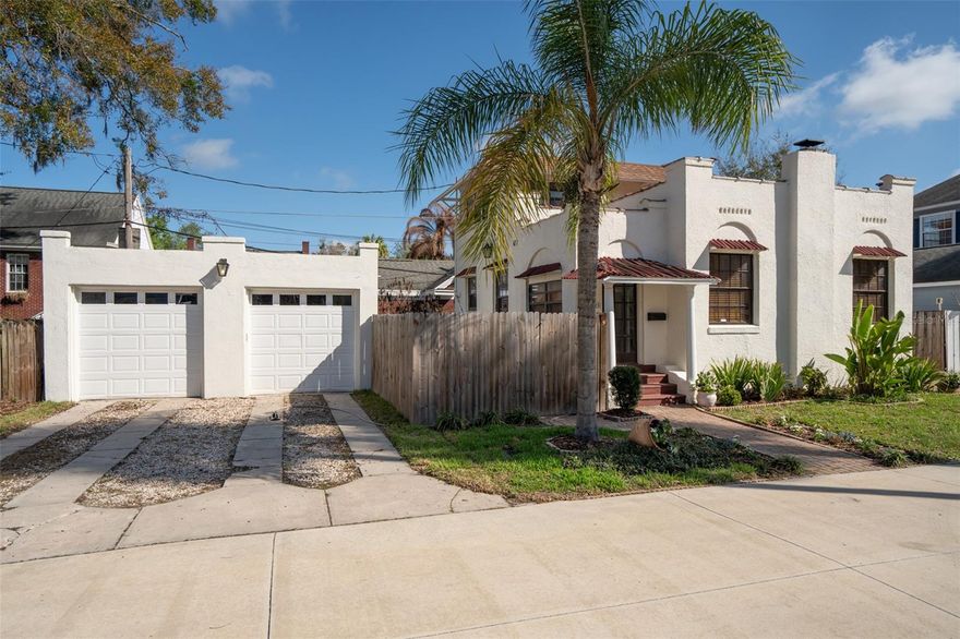 This truly lovable 1923 Mediterranean Revival is nestled in the Eola Heights Historic District, just an easy walk to Lake Eola. Located on a quiet street only blocks from the business district, restaurants, farmers market, nightlife, and all that downtown has to offer, this home combines historic charm with an unbeatable location.

Filled with character, this home lives large and is ideal for entertaining, offering generous indoor and outdoor living spaces, two courtyards, and a two-car garage. The open floor plan features a cozy living room with a fireplace, refinished oak hardwood floors, lofty ceilings, plaster walls, archways, and a staircase adorned with colorful hand-painted Mexican tile. The spacious kitchen is beautifully updated with new 42-inch cabinets with glass fronts, dolomite countertops, new appliances, and even a view of the Orlando skyline from the kitchen window.

The bathroom features a walk-in shower, handsome black fixtures, and slate tile. The primary bedroom is located downstairs, with two additional bedrooms upstairs. An inside utility room just off the kitchen leads to a private courtyard with brick pavers.

Recent improvements include a recently replaced roof, fresh interior and exterior paint, New Central Air and Heat, and a termite bond for added peace of mind. Low-maintenance and offering ample parking, the two-car garage also provides lots of possibilities with power, a window unit A/C, and an electric garage door opener.

A rare opportunity to own a character-filled home in one of downtown Orlando’s most desirable historic neighborhoods. THANK YOU EOLA HEIGHTS for honoring The Hibiscus house with the "Garden of the month"