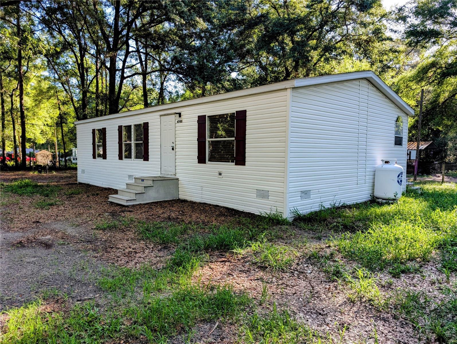 From first time home buyers to investors, we have lenders that can help you purchase this beautiful home on a half acre!! Great Air bnb potential with Alexander Springs and Wiregrass UTV trailhead right up the road. This oversized lot boasts 3 bedroom, 2-bath home!! You will love the huge back deck and the grilling station for enjoying time with friends and family! This getaway is nestled on a 1/2 Acre fenced lot in the Ocala National Forest, allowing for any outdoor amenity you enjoy!! Upgrades abound, including a brand new well and A/C system installed in 2025, brand new bathrooms, new custom slat blinds, great kitchen with beautiful cabinetry and stainless steel appliances, as well as new flooring throughout, tile in common areas, carpet in the bedrooms. Financing available, come take a look today!!