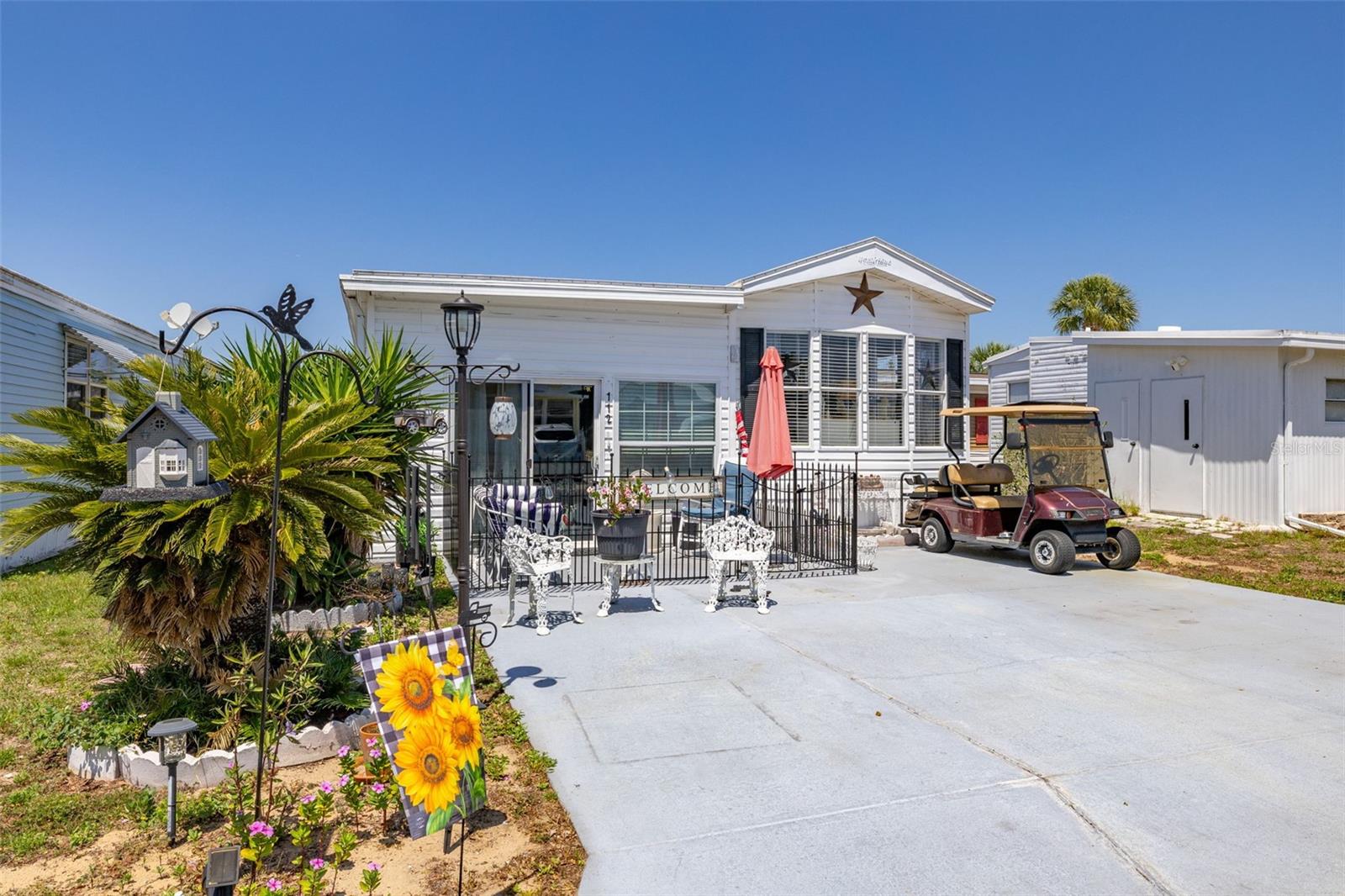 Embrace carefree Florida living in this delightful 1 bed, 1 bath home within the vibrant 55+ Center Crest community of Davenport! You OWN THE LAND here, offering true peace of mind. Enjoy modern comforts with a new, only 9-month-old air conditioner, stylish new vinyl plank flooring, and updated windows. The added air-conditioned extension provides flexible living space, perfect for guests. Entertain with ease in the spacious living room. Pet owners will appreciate the gated front patio, while everyone will love relaxing under the backyard shade canopy. Convenience is key with a stackable washer/dryer and a handy shed. Imagine creating your own private oasis with a lattice fence in the back. The active community clubhouse offers year-round fun, from craft shows to bingo, plus a refreshing pool and shuffleboard – all with an incredibly low $58 monthly HOA! Don't let this worry-free opportunity pass you by. Call now for a showing!