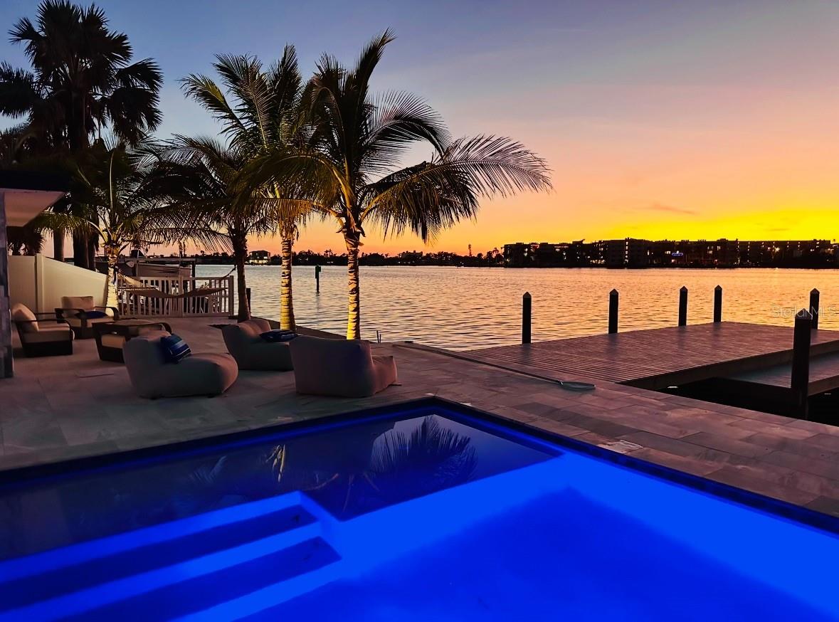 Experience true waterfront living and unforgettable sunsets from your own backyard in the highly sought-after Pasadena Golf Club Estates, located in unincorporated Pinellas County. This fully renovated coastal retreat is a boater’s dream, offering deep water docking on the Intracoastal Waterway of Boca Ciega Bay, with easy access to Tampa Bay and the Gulf of America!
The 2019 wide-depth seawall supports a brand new TREX dock, featuring a 12x36 main dock and a 4x24 lower dock, ideal for all your water toys and marine adventures. Cool off in the brand new saltwater pool, set in a luxurious imported marble decking and surrounded by lush coconut and Tahitian palms—part of a landscape investment of over $50,000.
Inside, you’ll find over-the-top upgrades and thoughtful design touches throughout, including:
Custom-designed kitchen with over 30 feet of counter space, solid wood cabinetry, brushed gold hardware, 36” porcelain farmhouse sink, GE Monogram appliances including a 48” gas range and 48” refrigerator, and a custom wet bar with an oversized wine cooler (holds 90+ bottles)
LVP flooring in bedrooms, mosaic tile, and all new LED lighting & fixtures
Spacious Living Room with a wood-burning fireplace
Primary Bedroom with water views, three closets, and an en-suite bath
Indoor Laundry Room with matching custom cabinetry
Tankless water heater, 2023 A/C, epoxy garage floor, and marble paver circular driveway
This home offers three bedrooms, two bathrooms, and a layout perfect for both relaxing and entertaining. Enjoy 86 ft x 100 ft of land (.197 acre) and .203 acre of deeded water rights.
All of this is just 10 minutes from St. Pete Beach and the Gulfport Arts District, and only 15 minutes to vibrant Downtown St. Pete, filled with award-winning dining, shopping, and entertainment.
Don't miss this rare opportunity to own deep water access and breathtaking waterfront views in one of the area’s most desirable neighborhoods. Schedule your private showing today!