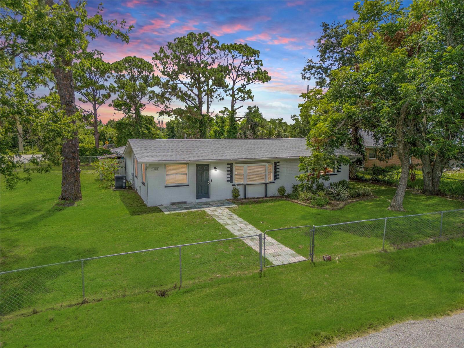 Welcome to your Florida lifestyle home just minutes from the Intracoastal Waterway and a short drive to the sandy shores of New Smyrna Beach! Situated on a massive corner lot in a quiet, established neighborhood, this 3-bedroom, 2-bath home offers 1,539 square feet of well-planned living space and a world of outdoor possibilities. Whether you’re an outdoor enthusiast, boater, or just love extra room to spread out, this property has space for it all—including your RV, boat, or other toys. Inside, you'll find a bright and functional layout perfect for full-time living, seasonal getaways, or investment potential. The spacious back patio is ideal for entertaining or simply enjoying a peaceful evening under the stars. Out back, a large shed offers additional flexibility and could easily be converted into a guest suite, private office, or hobby space. Residents of Edgewater love the friendly, down-to-earth vibe and the strong sense of community that comes with living in this charming coastal town. From farmers markets and art festivals to car shows, local concerts, and holiday parades, there's always something fun happening to bring neighbors together. Plus, you're just minutes from riverfront parks, public boat ramps, and all the shopping and dining options the area has to offer. Live where others vacation and enjoy the best of Florida's laid-back lifestyle—plenty of space, natural beauty, and a close-knit community, all just a short ride from the beach and river.