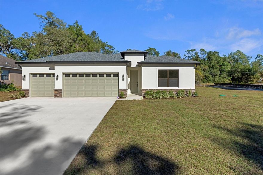 Price Reduction!  Welcome to 7835 N Creek Way!  Construction is complete and is move-in ready.   This home has a modern design and plenty of space. Sitting on a .30-acre corner lot, giving you plenty of privacy, yet is walking distance to schools and the Withlacoochee Bike Trail. The open floor plan features 4 bedrooms, 3 full bathrooms, and a 3-car garage. One bedroom includes a private en-suite bathroom.  Upgraded finishes throughout the home include quartz countertops, 42 inch shaker cabinets, stainless steel appliances, ring doorbell, dual closets in the primary bedroom, washer & dryer, covered lanai, and luxury vinyl plank flooring in every room. The upgraded 9 foot, 4 inch ceilings make this home feel open and spacious.  Located just 1.5 hours from Orlando and Tampa, with local shopping and dining only 15 minutes away. With no HOA, you have the freedom to personalize the space to fit your needs.  This home comes with a builder 2/10 warranty.