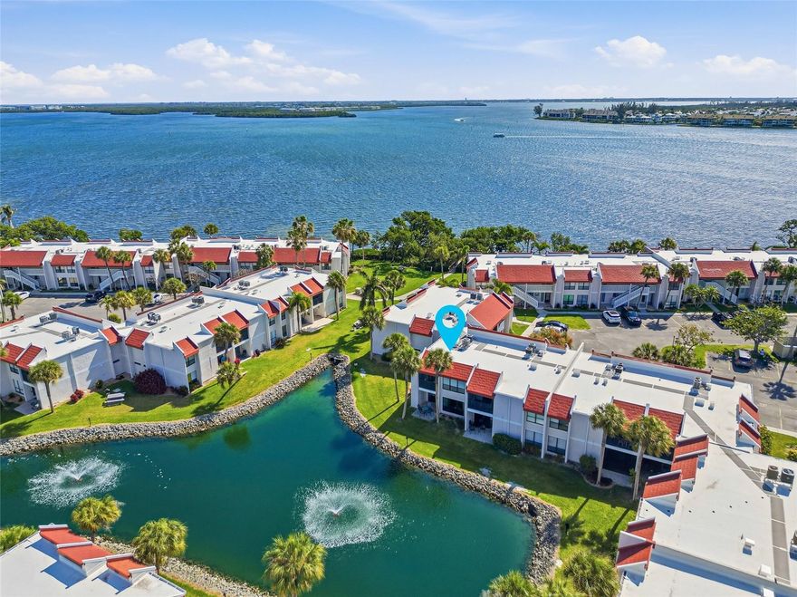 Welcome to Runaway Bay, a vibrant island style waterfront community in Bradenton Beach, where coastal charm meets exceptional investment opportunity. With weekly rentals permitted, this sought-after destination offers the perfect balance of personal enjoyment and income potential.  This beautifully updated 1-bedroom, 1-bath ground-floor condo captures serene lagoon views, complete with the soothing sounds of the fountain just beyond your door. Step inside to a light-filled interior where recent renovations create a fresh, airy coastal feel. Natural light pours through the space, immediately drawing your eyes to the water and enhancing the relaxed island ambiance.  The spacious primary suite serves as a peaceful retreat, offering tranquil lagoon views to greet you each morning. Enjoy your coffee or unwind in the evening on the private lanai, ideally positioned for both privacy and picturesque surroundings.  Thoughtfully upgraded throughout, this condo is truly move-in or rental ready, featuring hurricane-impact windows and doors, along with updated kitchen and bath finishes, flooring, trim, interior doors, appliances, water heater, and furnishings.  Runaway Bay continues to impress with extensive community enhancements, including new roofs and gutters, and a host of resort-style amenities: deeded beach access, a newly built oversized bay front observation and fishing pier, the largest heated pool on Anna Maria Island (recently renovated), refreshed pickleball and tennis courts, shuffleboard, a kayak launch, multiple grilling areas, and a clubhouse with a fitness center currently being revitalized.  Whether you're searching for your own island escape or a high-performing vacation rental, this exceptional property delivers the best of both worlds.