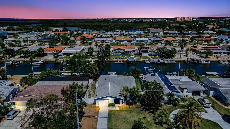 One or more photo(s) has been virtually staged. Waterfront Gem in Gulf Harbors – Fully Renovated & Move-In Ready! Welcome to your slice of coastal paradise in the highly desirable Gulf Harbors community! This beautifully renovated 2-bedroom, 2-bathroom home offers effortless waterfront living with modern upgrades and a thoughtfully designed open floor plan. Step through your private entry into a charming enclosed courtyard, setting the tone for both comfort and privacy. Inside, the seamless flow between the kitchen, dining, and living areas makes entertaining easy and enjoyable. The updated kitchen features a gas cooktop, a spacious island, and plenty of room for gathering. Wake up to stunning water views in the primary suite, complete with a private en-suite bathroom and a walk-in closet. The guest bedroom overlooks the tranquil courtyard, offering a peaceful retreat for visitors or family. Out back, enjoy approximately 60 feet of waterfront with endless possibilities—expand your dock, create your dream outdoor oasis, or add a pool. The large yard includes mature trees and a side dog run for added convenience. The enclosed Florida Room provides flexible space perfect for entertaining, a home office, or additional sleeping quarters. Embrace the Florida lifestyle with easy access to boating, fishing, kayaking, and paddleboarding right from your backyard. Residents also have the option to join the private beach club and enjoy access to two private boat ramps. Ideally located near shopping, dining, entertainment, and just a short drive to Tampa, this home offers both relaxation and convenience. Don’t miss your chance to own this waterfront retreat—schedule your showing today!