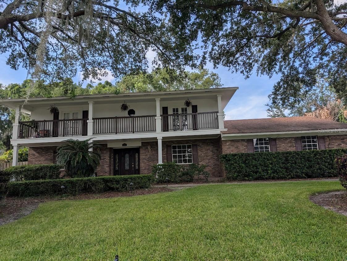 Classic Colonial Brick Home on highly desired E Adama Drive across from Lake Maitland! 4 bedrooms, 4 Baths, 2 fireplaces-one in Primary bedroom! Full 2nd floor balcony porch with French doors! Terrific home for entertaining! Formal Dining room across from Formal Living room connected by large foyer! Family room/Library with built in shelves on both ends with wood burning fireplace! French door lead to huge covered screened room with summer kitchen. Sip morning coffee while overlooking inground pool! Relax on your huge front porch while watching the squirrels play in the mature trees serenaded by a variety of musical birds! Two car garage with long driveway