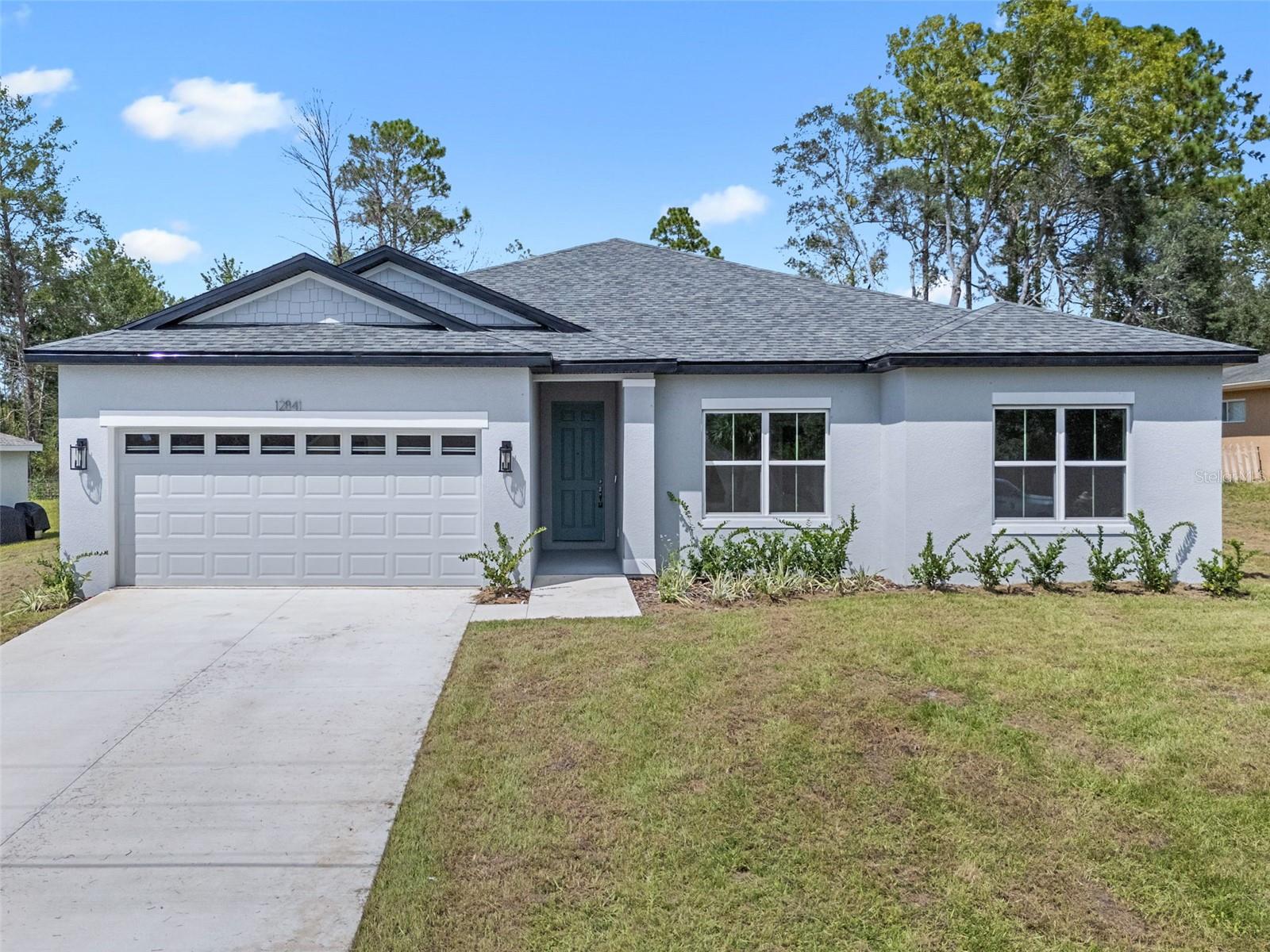 2025 NEW BUILD - 4 BEDROOMS 3 BATHROOMS with 2,092 square feet of living space! This home has a Full 2 Car Garage + 0.24 Acres in Marion Oaks. This BRAND NEW HOME features an open concept split plan with beautiful finishes throughout. The kitchen is complete with Quartz countertops, subway tile backsplash in a herringbone pattern, crown molding with staggered white cabinets, oversized pantry with Custom Sliding Barn Door, and large kitchen island with bar top seating. The kitchen opens to the living room area with tons of natural light and views of the CONSERVATION BACKYARD! This home is a true split plan. The primary bedroom has a tray ceiling and oversized walk-in his & hers closets. The primary bathroom has a custom quartz topped dual vanity, along with a walk in glass shower enclosure with floor to ceiling tile. On the opposite side of the home are three bedrooms, a full bathroom accessed by the hallway with a THIRD Full Bathroom as an EN-SUITE that makes a perfect IN-LAW SUITE or GUEST Suite. The laundry room has a Brand New Washer & Dryer. This NEW CONSTRUCTION HOME is full of other upgrades throughout: Luxury Vinyl Plank flooring, custom built drop zone just inside the garage entrance, and a large driveway. The Builder Preferred LENDER IS OFFERING 1% OF PURCHASE PRICE TOWARDS BUYER’S CLOSING COSTS! ***All homes come with a 2-10 Home Buyers Warranty*** Call to make an appointment to see this home today!