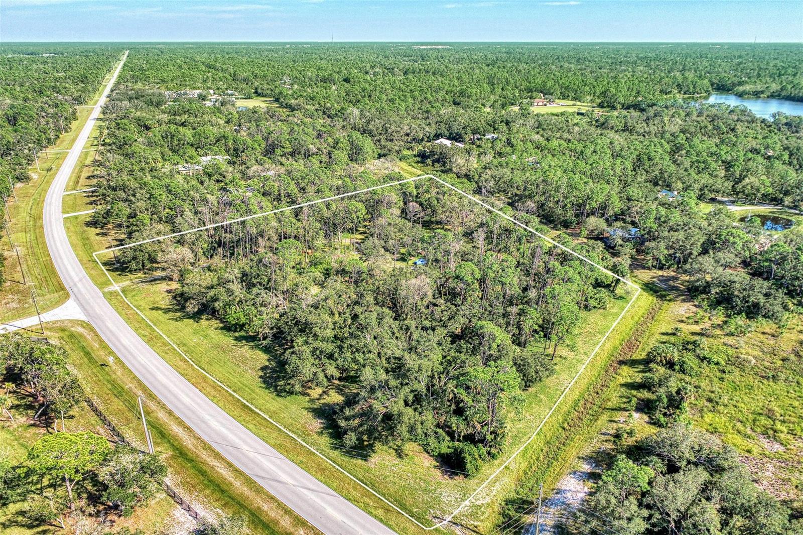 Discover your ideal retreat on this 4.7-acre gem nestled in North Port Estates on Tropicaire Blvd. This expansive lot is primed for your dream home, boasting a pre-cleared area for your perfect house and auxiliary structures like a garage or barn. Zoned for agriculture, it welcomes your animals and horses, ensuring endless equestrian possibilities. Just a stone's throw away from the Myakkahatchee Creek Environmental Park, you'll have access to walking and horse trails for outdoor adventures. Embrace the serene country lifestyle while being only minutes away from shopping, entertainment, and more. Your peaceful haven awaits!