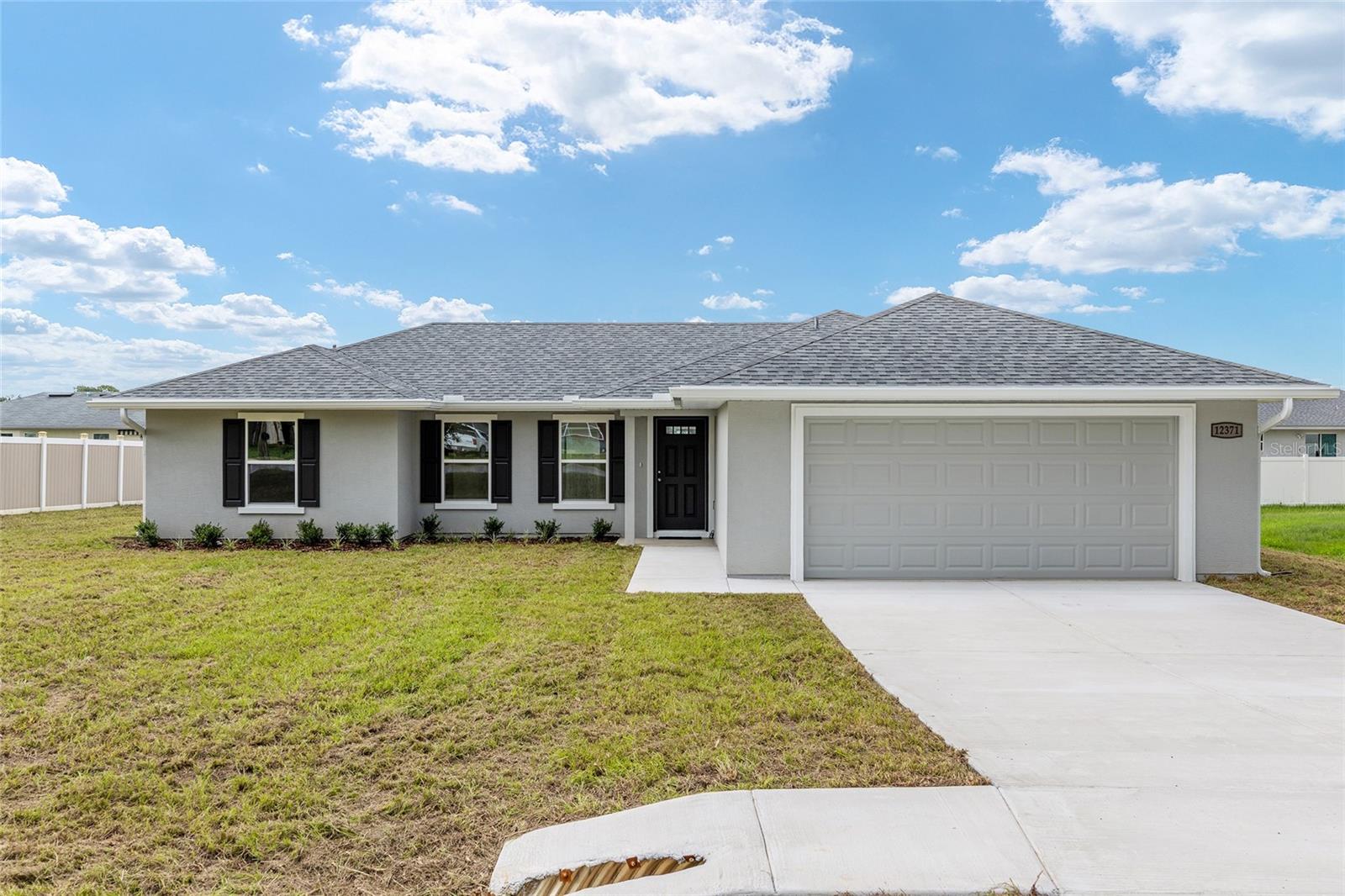 A lovely family-oriented community just minutes from Lake Weir! The Hills of Tuscany presents an opportunity for both value and style in Marion County with no HOA fees! This community is convenient to The Villages®, Belleview, and Ocala, making it a wonderful place to call home!As you walk through the front door of the home, you feel the openness with cathedral ceilings in the living room, dining room, and foyer. The kitchen features stylish cabinetry and quartz countertops and come complete with new range, microwave, and dishwasher. The charming nook is the perfect spot to enjoy your morning coffee. Tile floors throughout the house help with easy maintenance. There is fully tiled walk-in shower and dual sinks in the en-suite bath. Do laundry with ease in the air-conditioned laundry room. This home rests on just under a 1/4 acre lot ~ enough room for the family & pets to play, but not too much yard workThe Hills of Tuscany offers the perfect balance of comfort and convenience. Premium medical facilities, stellar shopping, and a plethora of restaurant options are within close proximity. Lake Weir offers an endless assortment of recreational opportunities including fishing, swimming, canoeing, and jet-skiing. Nearby Ocala National Forest has over 300,000 acres of wildlife to explore and offers numerous hiking trails and a range of camping options. Disney, Orlando, and Tampa are less than 1 ½ hours away.The Builder is including a 1-year full warranty and a 2-10 home warranty! Any dimensions listed are approximate.