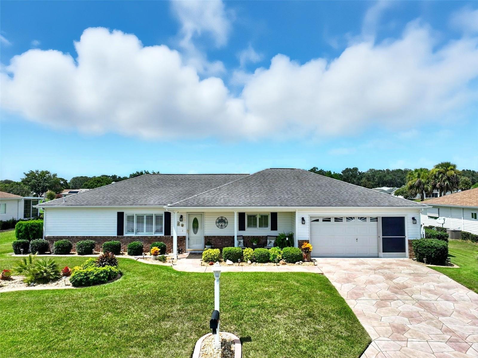 Meticulously Maintained Home with Golf Course Views in 55+ Gated Community. Extended Firr II Model 2BR/2BA home located on a large, irrigated lot with stunning golf course views. Street ends at a cule-de-sac for less vehicle traffic. This move-in ready home features vaulted ceilings, a spacious Florida room with glass windows, heating and A/C, and is partially furnished for convenience. Enjoy tasteful upgrades including crown molding in LR and DR, plantation shutters on the fronts window, 2" blinds throughout, vertical blinds in the Florida room, solar tubes for natural lighting, and a solar attic fan for energy efficiency. The kitchen offers a microwave over the stove, breakfest nook with bay window and golf course view, also a dedicated indoor laundry room with storage, garage utility sink, and plenty of storage space. Includes referigator in garage. Roof and water heater replaced in 2014. This home also features an 20x23 garage with floor tiles and sliding screens. Boasts a well-kept yard maintained by an irrigation system. ADDED BONUS, Electric 48 V 2-seater golf cart stays with the house. Located in a 55+ gated community (not an HOA), with a monthly amenities/recreation fee that provides access to community activities and facilities along with a 24 hr. security guard. Golf cart community (seperate fee for golfing) with access across Hwy 441 to stores, Doctors, banks....DON' LET THIS ONE SLIP THROUGH YOUR FINGERS, IT IS A RARE FIND. MOVE IN READY!