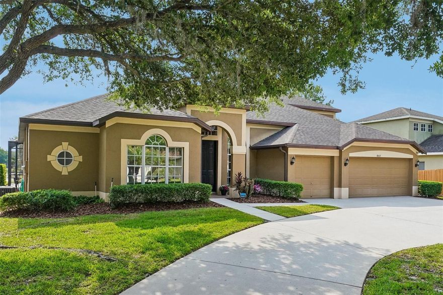Set on an expansive nearly half-acre cul-de-sac homesite with tranquil pond views, this exceptional luxury executive residence in West Meadows offers an impressive blend of elegance, comfort, and thoughtful design. A circular driveway and stately presence welcome you, complemented by a spacious three-car garage and lush surroundings that create a true estate feel.

Inside, the home unfolds with refined architectural details including tray ceilings, art niches, rounded archways, and 5 ¼-inch baseboards, all enhanced by plantation shutters and upgraded lighting and ceiling fans throughout. Luxury vinyl plank flooring flows seamlessly through the main living areas, accentuating the open-concept layout that is both inviting and ideal for entertaining. Formal living and dining rooms provide sophisticated gathering spaces, while a dedicated office offers the perfect work-from-home retreat.

At the heart of the home, the chef’s kitchen is a standout feature, boasting rich solid wood cabinetry, granite countertops, stainless steel appliances, and a gas range with a custom hood vent. A massive center island with seating and pendant lighting anchors the space, while under-cabinet lighting and a built-in wine fridge add both function and flair. The kitchen opens effortlessly to the family room, creating a spacious and connected living environment.

Designed with privacy in mind, the split-bedroom layout ensures a serene primary suite, complete with private sliders leading to the lanai. The en suite bath is equally impressive, featuring dual rectangular sinks, a dedicated vanity area, and a large walk-in shower with a frameless glass enclosure. A secondary bedroom with its own en suite bath and lanai access is perfect for guests or multigenerational living.

Upstairs, a generous bonus area along with a fifth bedroom and full bath provides flexible space for a media room, guest suite, or playroom, along with a massive storage closet to meet all your organizational needs.

Step outside to your private oasis where a screened-in lanai showcases a sparkling pool and spa overlooking the peaceful pond—perfect for relaxing or entertaining year-round. Additional features include natural gas service for the hot water heater, dryer, and heating system, as well as a whole-house water softener for added convenience.

This remarkable home offers the perfect balance of luxury, space, and functionality in one of Tampa’s most desirable communities.