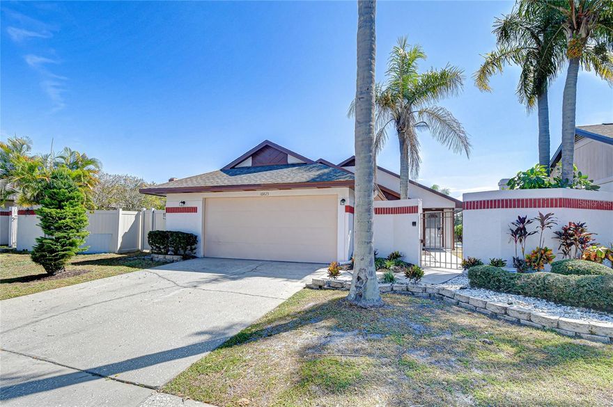 Step into sophistication and style in this beautifully renovated 1,485-square-foot home in the desirable Bayport West community! Behind the charming gated courtyard, you’ll discover a private tropical oasis, surrounded by lush palms, manicured landscaping, and clean architectural lines that set the stage for the elegance within, and set on a waterfront pond view.
Inside the foyer, a convenient coat closet, the open-concept great room impresses with soaring vaulted ceilings, abundant natural light, and a striking fireplace with a custom mantle — the perfect centerpiece for relaxing or entertaining. A dramatic NEW 60” ceiling fan hangs gracefully from the 12’ ceiling, adding both comfort and flair. Newly installed luxury vinyl plank flooring flows seamlessly throughout the home, complemented by fresh 5-1/4” high baseboards and a modern, neutral palette, freshly painted, that enhances the sense of space and sophistication.
The stunning kitchen blends functionality with flair, featuring 42” shaker-style cabinetry, quartz countertops, a designer tile backsplash, recessed lighting, pantry, and a full suite of NEW stainless-steel appliances including a smooth-top range, side-by-side refrigerator, microwave, and dishwasher. A cozy café nook offers the perfect spot for morning coffee overlooking the courtyard.
Enjoy two spacious primary suites, each offering NEW double vanities with drawers, quartz countertops, and undermount sinks. The main suite stands out with vaulted ceilings, a NEW ceiling fan, dual walk-in closets with built-in organizers, a linen closet, and a beautifully tiled tub/shower with glass enclosure.
The laundry area is conveniently located in the hallway behind bifold doors. From the great room double sliding glass doors complete with vertical blinds open to a covered lanai and extended patio, surrounded by fresh landscaping and a beautiful place for entertaining or relaxing outdoors.
Outside, unwind in in privacy as the fenced yard with fresh landscaping, ideal for outdoor dining or gardening. The attached garage and extended driveway provide added storage and convenience.
Additional highlights include a NEW 2025 water heater, roof (2014), HVAC (2012), and updated lighting fixtures, NEW storm door, and modern decora switches and receptacles throughout.
Located in Bayport West, you’re just moments from the Upper Tampa Bay Trail — perfect for biking, running, and rollerblading — as well as premier shopping, dining, and entertainment at Citrus Park Town Center. Commuting is effortless with easy access to major highways, Tampa International Airport, MacDill Air Force Base, and downtown Tampa as well as nearby award-winning beaches.
Experience the perfect blend of comfort, quality, and location in this move-in-ready gem. Schedule your private showing today and discover why Bayport West living is so special!