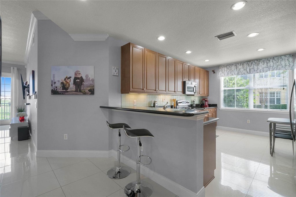 Photo of 7468 Excitement Drive #102, Reunion, FL 34747 (MLS # O6418716)