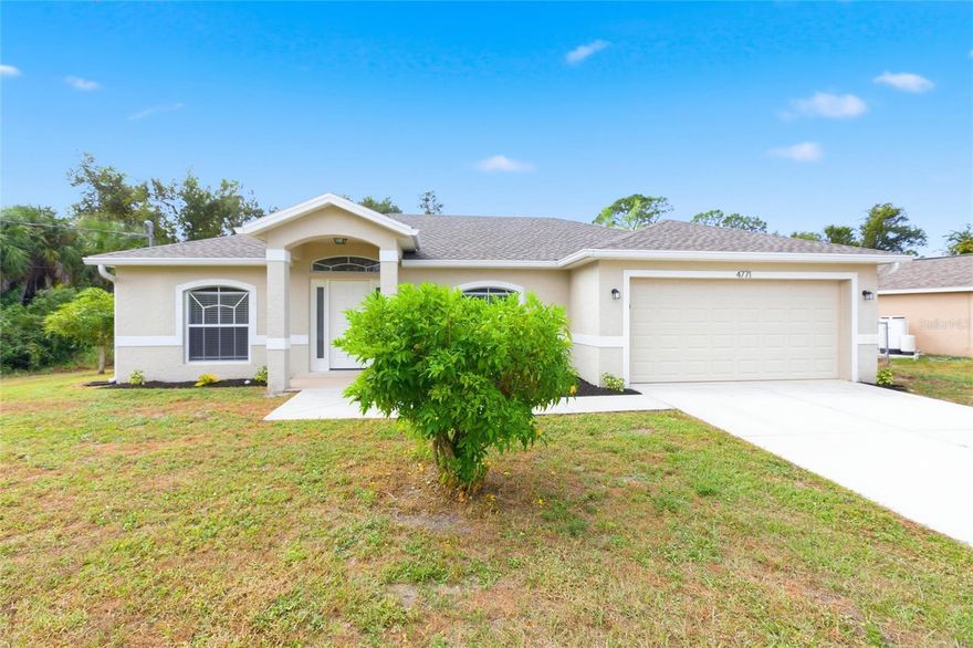 Welcome to 4771 Gratlyn Terrace in beautiful North Port, Florida — a light, bright, and move-in-ready 3 bedroom, 2 bathroom home with 1,297 sq ft of comfortable living space, a 2-car garage, and a desirable split floor plan. Built in 2007 on a pie-shaped lot, this property offers fantastic curb appeal with a huge front yard, attractive landscaping, and a high-ceiling front porch. Inside, you'll find freshly painted interiors, tile plank flooring throughout the main living areas, vaulted ceilings, and an open great room with a transom window, pendant lighting, and ceiling fans. The kitchen features stainless steel appliances, oak cabinetry, quartz countertops, and a dining nook with an updated light fixture. Bedrooms have brand-new carpet and each includes a ceiling fan. The guest side of the home offers two bedrooms, a linen closet, and a tiled tub/shower combo bath with a low-flow toilet. The primary suite includes a walk-in closet, ensuite bath with walk-in shower and handheld showerhead, and sliding glass doors to the back patio. Bedroom three also opens to the outdoor living space, making it a great flex room or home office. Enjoy a fully fenced backyard and spacious patio perfect for pets, play, or entertaining. Property is located in an X flood zone, meaning no flood insurance required, and the HVAC was replaced in 2023 for peace of mind. Conveniently located near shopping, restaurants, golf, schools, parks, and Gulf beaches, this North Port home is a fantastic opportunity for full-time or seasonal living.