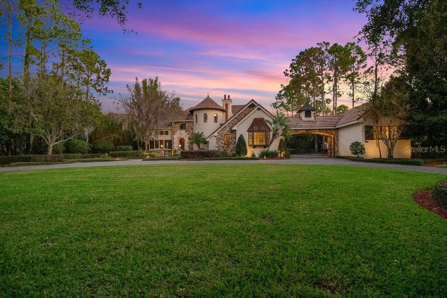 Welcome home to your magnificent custom estate poised on an acre lot on one of the most prominent streets in Central Florida. Nicknamed Moon Shadow, by the award-winning builder Jones Clayton, this captivating home totaling close to 10,000 sq ft is a timeless architectural masterpiece with its stately well balanced curb appeal showing an unparalleled attention to details on quality & perfection that includes pristine manicured grounds. As you pass through the gates you will be greeted with fountains flanked on each side, elegant stone work façade, and a stately solid wood door with leaded glass. Prepare to be mesmerized upon entering with the attention to detail throughout including a sweeping staircase around the turret and large windows complimented by high ceilings flooding the home with natural light. The foyer showcases the castle’s courtyard pool and outdoor space which helped win an award for The Street of Dreams Best Architectural Design & Landscaping. The right vestibule leads to an elegant grand dining room with gorgeous detailed ceilings, 250+ bottle wine cellar, Sub Zero wine refrigerator, and butler’s pantry. The fully equipped gourmet chef’s kitchen open to the family room is a dream with a large center island, custom solid wood cabinetry, stone countertops, Viking double oven six burner range with griddle, Thermador refrigerator and freezer with custom paneling, two dishwashers, two sinks, and includes a hidden walk-in pantry. Master bedroom suite with a gas fireplace offers the ultimate privacy & tranquility with easy access to your resort pool. The spa like master bathroom includes a studio that can be used as an gym or owners retreat, oversized walk-in closet, tub, shower, steam shower, two water closets, and access to an outdoor rain shower and sauna. Secondary bedrooms are all en-suite with plenty of closet space. Two of the bedrooms are ideal for in-laws or guests as they are accessible through a breezeway and courtyard. The upstairs media room includes a wet bar, beverage refrigerator, and built-ins for your library. The air conditioned “Bridge Room” over your lazy river makes for a fun game room, gym, or whatever your heart desires. Your timeless castle has an unparalleled outdoor living space compared to none! The fully automated resort pool includes a spa, lazy river, water features including fountains, rock waterfall with slide, a separate 65’ lap pool, and fully equipped summer kitchen with motorized screens. The outdoor space can entertain hundreds or just your close loved ones with lush mature landscaping offering the ultimate sense of privacy from within your backyard. Additional features include a three-car garage with your own gated motor court. Reserve at Lake Butler Sound is 24-hour guard gated neighborhood with an additional back gate providing easy access to Windermere Preparatory School. Location is close to Orlando’s major attractions, shops, restaurants, and “A” rated schools. Be prepared to enjoy the extraordinary lifestyle this castle offers to anyone that passes through Moonshadow’s doors.