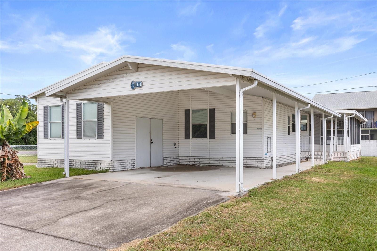 Tucked away in the heart of Florida’s storied Space Coast, this lovingly maintained double-wide manufactured home offers more than just a place to live—it offers a lifestyle rooted in comfort, convenience, and classic Old Florida charm. With an open floor plan, soaring ceilings, and a cozy wood-burning fireplace, the living space is made for easy living and effortless entertaining. Slide open the glass doors and enjoy the enclosed side porch or relax under the covered patio with evening breezes.
The kitchen features a wall oven and center island cooktop, perfect for preparing meals while staying connected to the heart of the home. The expansive primary suite is a retreat of its own, complete with a soaking tub, dual vanity, and separate shower. A spacious second bedroom, full bath, and dedicated laundry room complete the interior, while a generous carport and extended driveway provide parking for 4+ vehicles.
Located in Rockledge—the oldest city in Brevard County—you’re minutes from the Indian River, historic neighborhoods, top-rated schools, and the vibrant shops and dining of nearby Viera. With close proximity to Patrick Space Force Base and the Kennedy Space Center, this home is ideal for first-time buyers, downsizers, or investors seeking a quiet community with deep roots and strong appeal.