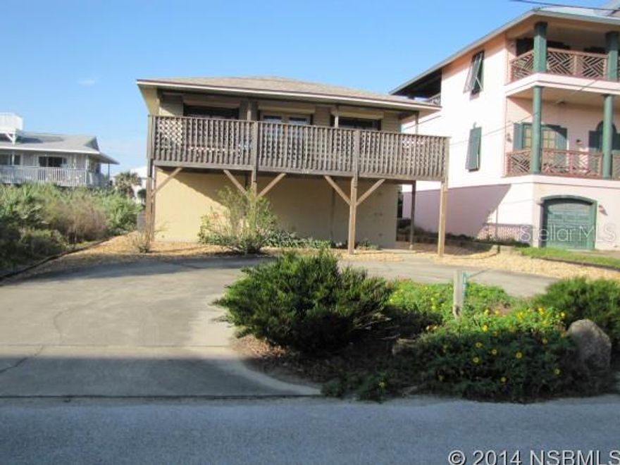 Beachside home close to the Canaveral Seashore. Just a short walk to the public beach walkover and river. Spacious deck with peekaboo view of ocean. Open floor plan. Two bedrooms and two baths upstairs. Downstairs has a large room could be another bedroom or family room and bath.. Oversized double car garage with storage closet and a dumb waiter from garage area to kitchen. Large lot. This house fronts South Atlantic with a circular driveway in the front. The entrance to the garage is from Turtlemound. No driving on the beach area. ;Water: City