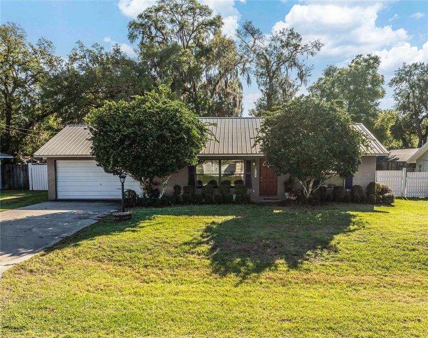 Welcome to this charming single-family home nestled in the peaceful Country Walk community of Belleview in Marion County. Situated on a spacious lot of just under half an acre, this inviting 3-bedroom, 2-bath residence offers the perfect blend of comfort, functionality, and relaxed Florida living, now enhanced with a durable and attractive metal roof for long-term value and peace of mind. With 1,416 square feet of living space, the home features a practical layout designed for everyday ease. The welcoming living room serves as the heart of the home, providing a comfortable space to unwind, while the kitchen offers ample room for meal preparation and flows seamlessly into a cozy dining area—ideal for both casual meals and gatherings. One of the standout features of this home is the bright and airy Florida room located at the rear of the property. Surrounded by large windows, this versatile space is perfect for enjoying morning coffee, relaxing with a good book, or taking in views of the backyard while staying comfortably indoors. Step outside to enjoy the expansive, fenced backyard, offering plenty of room for pets, play, or future outdoor enhancements to suit your lifestyle. Whether you envision a garden, outdoor seating area, or entertaining space, this yard provides a blank canvas to make it your own. Additional highlights include an attached garage for convenient parking and storage, as well as an indoor laundry area for added efficiency. Located on a quiet street with no HOA fees, this home offers both peace of mind and affordability. Ideally positioned just a short drive from The Villages Charter School system, as well as major shopping options including Costco, Sam’s Club, Publix, and other everyday conveniences, this property combines a tranquil setting with easy access to some of the area’s most desirable amenities.
