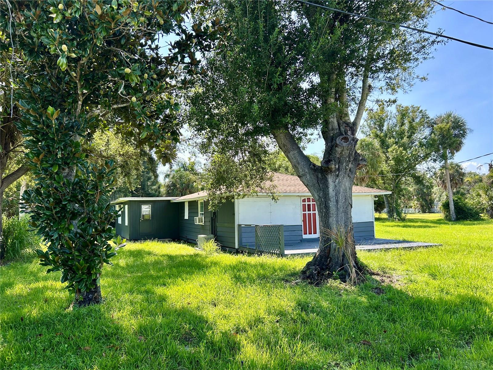 Build your ultimate multi-generational paradise on this oversized, serene lot with mature trees. With two fully independent septic tanks and dual electric service panels already installed, the groundwork is set for a main home (manufactured homes are okay) plus zoning allows for a guest house or Airbnb to be built. A guest house accessory structure can have a kitchen, bath(s), bed(s), and general living space. A buyer should check with Charlotte County for the most recent rules/or fees. This property provides unmatched flexibility—no HOA, no CDD fees, paved road access, and public water. Enjoy the convenience of downtown Punta Gorda, Sunseekers Resort, nearby shopping, dining, boating, and the airport. Date St runs directly to the Peace River. If you love fishing, there may still be a path to the river where you can sit and enjoy your favorite pastime. If you're designing custom family quarters, this lot delivers the perfect foundation. Don’t miss this turnkey-ready canvas for your dream build in one of Florida's desirable coastal communities! Being sold for land value only. House is a demo.