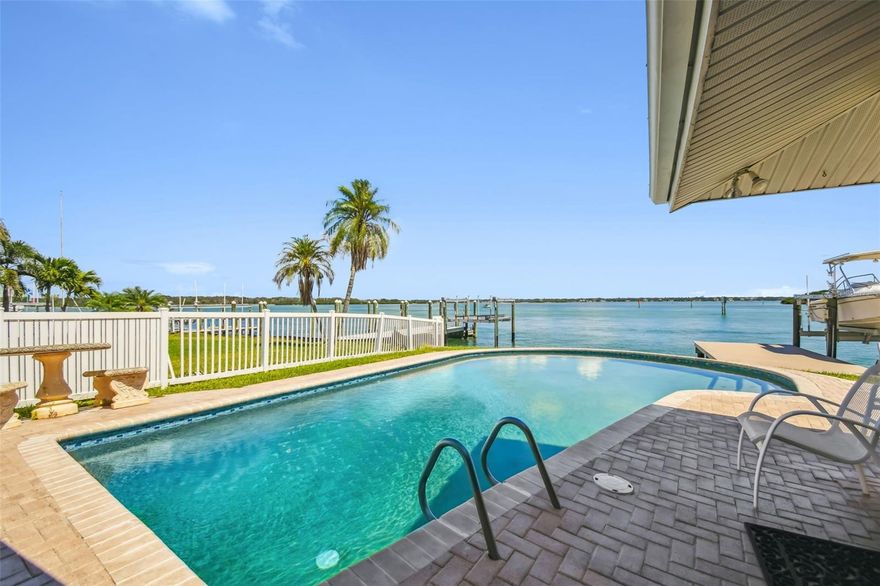 LIVE THE DREAM! Move-in ready with all the work done. This exceptional property offers one of the finest views across the waters of Boca Ciega Bay just minutes to the Gulf of Mexico and Johns Pass.  You'll enjoy a location that everyone envies and few experience in this 4-Bedroom / 2-Bath Pool Home. With 70 feet of deep water frontage along a minimum wake zone, you'll have easy harborage for your boat and toys, and a breathtaking view of Bird Island and views 2 miles across the bay. The home offers 2,273 HSF, a 2-car garage, inside laundry, and a kitchen with water views open to the family room perfect for true Florida living.  The split bedroom plan features an en-suite Master overlooking the pool and water, while two defined living areas provide ample room for guests or family gatherings. The Tampa Bay intracoastal waters deliver endless fishing, dining, and boating opportunities along the coast.  Recent storm-related water damage was promptly addressed, making for an effortless move-in. Located in the heart of Madeira Beach, you're close to some of the finest beaches in the country, with quick access to downtown St. Petersburg's arts and Pier districts, Tampa Bay's sports and entertainment venues, and Tampa International Airport.  Seller will consider short-term Seller Financing with a 1st Position mortgage at current rates.