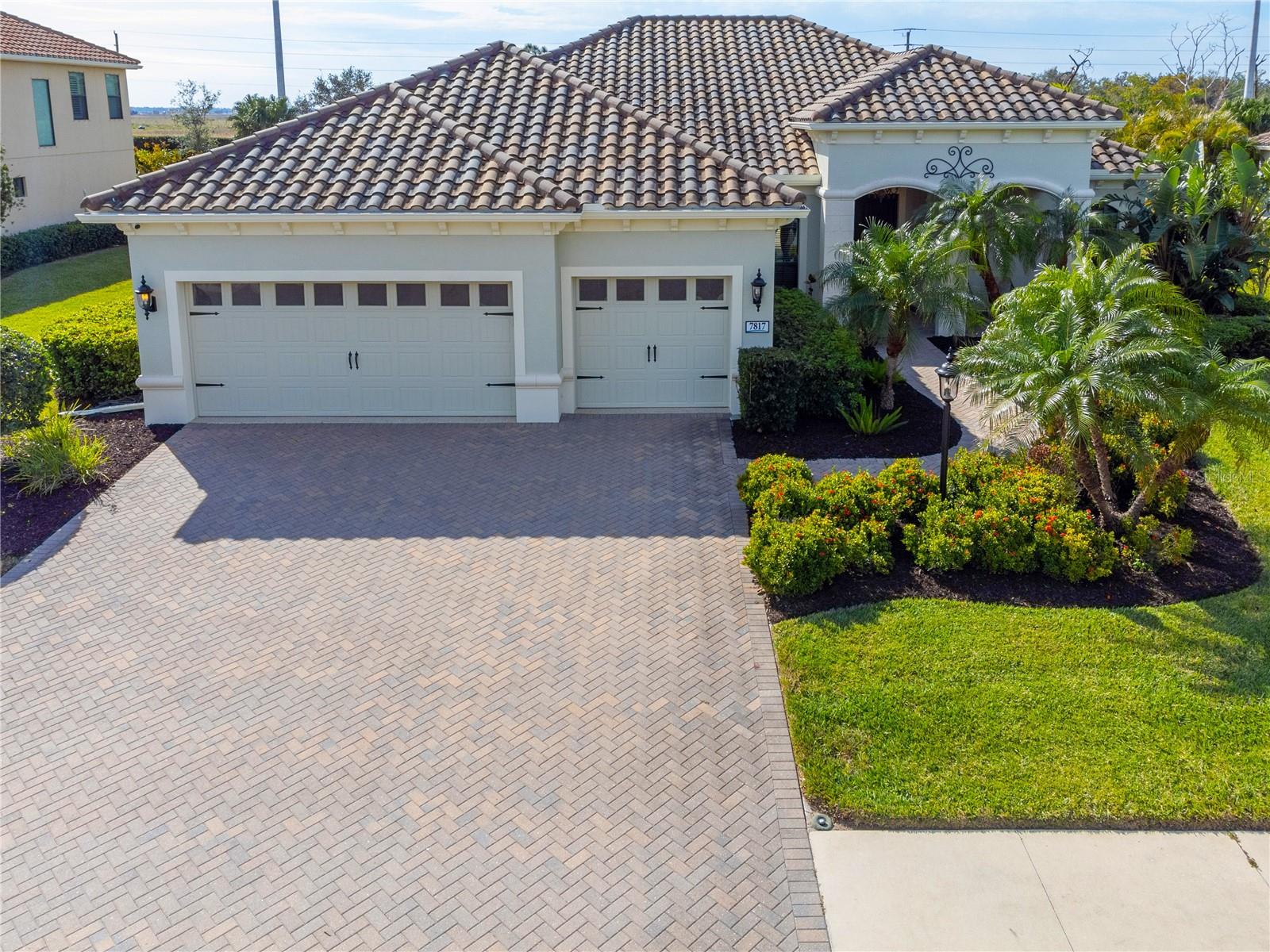 Welcome to Wildgrass, an exclusive gated community offering estate-size almost 1/2 acre lots, just minutes away from shopping, dining, and entertainment, and a short drive to the stunning Siesta Key Beach. This exquisite 4-bedroom, 3-bath pool home embodies the luxury and craftsmanship of a Neal Signature Homes. From the moment you drive up, you will be captivated by the beautifully manicured lawns and lush landscaping, with a stunning elevation, paver walkway and driveway that set the tone for the elegance within. Inside, architectural details abound, including arches, step ceilings, columns, crown molding, and more, providing an ambiance of sophistication throughout.
The gourmet kitchen is a true masterpiece, featuring custom wood cabinets, granite countertops, decorative tile backsplash, stainless steel appliances with a gas cooktop, built-in convection oven and microwave oven, and a stainless steel cooktop hood. A large breakfast bar with pendant lighting offers ample seating, making it perfect for family gatherings or casual meals. The open and airy floor plan continues to impress with interior and exterior gathering spaces, and a spacious primary suite that offers direct access to the pool area, two large walk-in closets, and an elegant bath with dual sinks, granite countertops, custom cabinetry, a soaking tub, and a large walk-in shower with a frameless glass door. The additional bedrooms provide plenty of space for guests, while the versatile 4th bedroom, with engineered wood flooring and direct access to the outdoor living area, can serve as a home office. The 4th bedroom also has an adjacent bath, which functions as both a pool bath and a convenient guest bath. Step outside to the expansive outdoor living area, featuring a large pool with a PebbleTec finish, a soothing waterfall water feature, and a newer outdoor kitchen with a built-in grill, sink, refrigerator, and granite countertops. The travertine flooring, recently sealed, adds a touch of luxury, and lush landscaping ensures privacy for your enjoyment. The 3-car garage is impeccably designed with newly epoxied floors and offers plenty of space for both vehicles and storage. Notable upgrades include a dishwasher, outdoor kitchen, gutters and downspouts, garbage disposal, fresh interior and exterior paint, epoxied garage floors, sealed travertine, indoor and outdoor fans, pool heater control pad, a Wi-Fi-enabled Rainbird irrigation control panel, and a Lorex outdoor security camera system. This home truly offers the best of indoor and outdoor living in one of the most sought-after communities. Don’t miss the opportunity to make this stunning property your own!