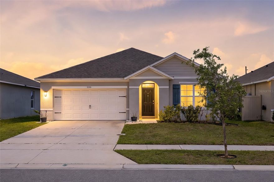 Set along the Narcoossee corridor in Barrington, this 2020 single-story home delivers a true split-bedroom layout, a generously scaled primary suite, and a rear exposure that opens to open pasture rather than another backyard. 3 bedrooms, 2 baths, and 1,672 square feet on a fully fenced homesite with a covered rear patio.
The entry opens through an arched foyer into the main living zone, where the kitchen, dining area, and living room share a single open plan lit by recessed can lighting. The kitchen anchors the center with white cabinetry, dark granite counters, under-cabinet LED lighting, a stainless appliance suite, and an island with an undermount sink and bar seating for three. A walk-in pantry is tucked just off the kitchen, and large-format gray ceramic tile runs throughout the main living areas. Sliding glass doors in the dining area look directly to the rear patio and open pasture view beyond.
The primary suite is privately positioned at one end of the home, set apart from the secondary bedrooms by the entire great room, and unusually generous at 13'2" by 22'3". Two windows look out toward the open pasture, with a ceiling fan already in place. The primary bath features white cabinetry, dark granite counters, dual undermount sinks, a tub with shower, a separate water closet, and clerestory windows above both the vanity and the tub for natural light without compromising privacy. A walk-in closet with direct bath access completes the suite. Two secondary bedrooms and a second full bath occupy the opposite wing.
Outdoor living centers on the view: a covered patio with ceiling fan looks across a fully fenced yard to open pasture beyond the rear line, with no home directly behind the property. Vinyl privacy fencing runs along both side yards, and the lot has room for a future pool without losing the sightline.

Barrington places Lake Nona Town Center, Medical City, Nemours, and the VA Hospital within a short drive, Orlando International Airport about 20 minutes out, and quick access to the 417 and 528.