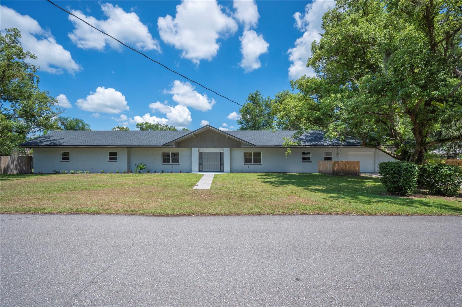USDA FINANCING AVAILABLE — NO MONEY DOWN FOR ELIGIBLE BUYERS! Contact us today for more details.
Set on over half an acre, this beautifully renovated home is spacious, stylish, and truly move-in ready. Step through the double entry doors into a stunning living area featuring rich wood-paneled walls, soaring beamed cathedral ceilings, built-in bookcases, and a striking stone fireplace — the perfect centerpiece for gatherings.
The open-concept layout seamlessly connects the living room to the dining area and a fully updated kitchen. Enjoy cooking and entertaining with brand-new stainless steel appliances, sleek quartz countertops, all-new cabinetry, and a large center island that offers additional seating, prep space, and storage.
Each bedroom has been updated with new carpet and ceiling fans, while the primary suite boasts an ensuite bath with a double vanity and a generous walk-in closet. Throughout the home, you’ll find luxury vinyl plank flooring, new windows, updated light fixtures, fresh interior paint, and plenty of hallway storage. Major system upgrades include a newer A/C unit (2021 per permit), two new electric water heaters, and more.
Outside, the home features a brand-new roof (2024), fresh exterior paint, and new landscaping. Enjoy the large fenced-in backyard, open rear patio, two-car garage, spacious driveway, and a detached shed — ideal for a workshop or extra storage.
Don't miss your chance to own this turnkey property with flexible financing options available!