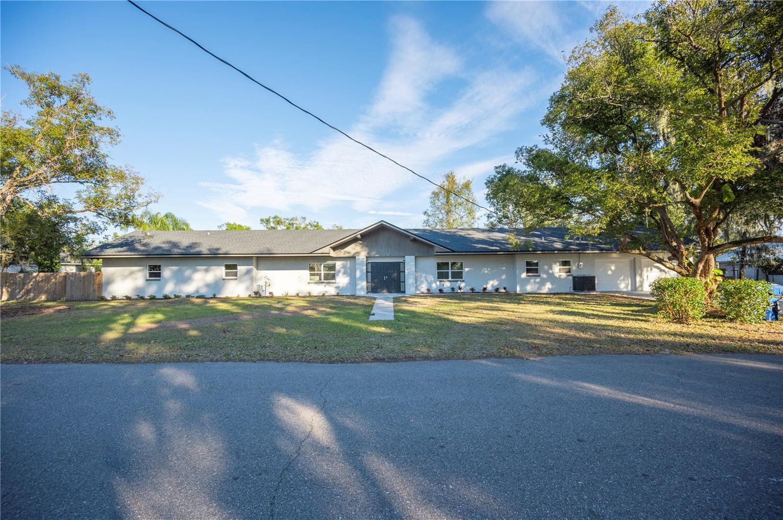 USDA FINANCING AVAILABLE — NO MONEY DOWN FOR ELIGIBLE BUYERS! Contact us today for more details.
Set on over half an acre, this beautifully renovated home is spacious, stylish, and truly move-in ready. Step through the double entry doors into a stunning living area featuring rich wood-paneled walls, soaring beamed cathedral ceilings, built-in bookcases, and a striking stone fireplace — the perfect centerpiece for gatherings.
The open-concept layout seamlessly connects the living room to the dining area and a fully updated kitchen. Enjoy cooking and entertaining with brand-new stainless steel appliances, sleek quartz countertops, all-new cabinetry, and a large center island that offers additional seating, prep space, and storage.
Each bedroom has been updated with new carpet and ceiling fans, while the primary suite boasts an ensuite bath with a double vanity and a generous walk-in closet. Throughout the home, you’ll find luxury vinyl plank flooring, new windows, updated light fixtures, fresh interior paint, and plenty of hallway storage. Major system upgrades include a newer A/C unit (2021 per permit), two new electric water heaters, and more.
Outside, the home features a brand-new roof (2024), fresh exterior paint, and new landscaping. Enjoy the large fenced-in backyard, open rear patio, two-car garage, spacious driveway, and a detached shed — ideal for a workshop or extra storage.
Don't miss your chance to own this turnkey property with flexible financing options available!