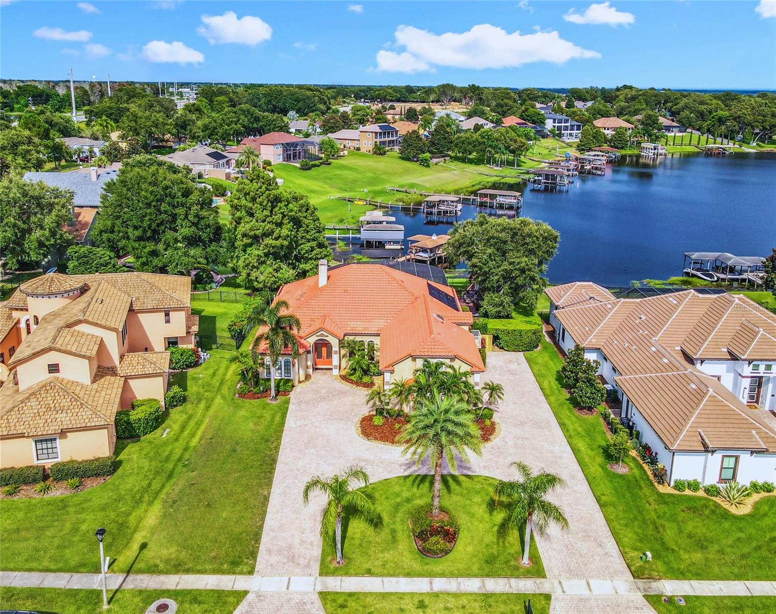 RARE LAKEFRONT OPPORTUNITY in the exclusive, gated community of John’s Cove!
This custom-built 4,373 square foot Mediterranean estate offers the ultimate Florida lakefront lifestyle with 5 bedrooms, 4 full bathrooms, both casual and formal gathering rooms, a spacious bonus room, pool, and private dock with boat lift on the nearly 2,600-acre watersports paradise of John’s Lake.
As you arrive, the expansive circular pavered driveway and stunning Mediterranean architecture create an immediate sense of distinction. Through the grand double doors, the impressive foyer opens to a home defined by elegance—honed and filled travertine floors, soaring ceilings with crown molding, oversized baseboards, and breathtaking pool and lake views.
The open, split-bedroom floor plan is thoughtfully designed for both comfortable living and effortless entertaining. The Formal Living Room and Great Room share a decorative glass fireplace, while the Formal Dining Room with an exquisite chandelier flows seamlessly into the kitchen. The 30-foot Florida Room, lined with sliding glass doors, provides uninterrupted water views. A wet bar with sink, ice machine, cabinetry, and refrigerator makes this space perfect for gatherings. Nearby, the Casual Dining area is the ideal spot to enjoy the sunrise over the water with your morning coffee.
The gourmet kitchen is a chef’s dream, featuring premium stainless steel appliances including a 36” ceramic cooktop, new high-powered vent hood, counter-depth refrigerator, double built-in ovens, microwave, two dishwashers, and built-in trash compactor. Rich granite countertops, solid wood cabinetry, generous butler’s pantry with pull-out shelving, and breakfast bar complete the space.
The first-floor Primary Suite is a private retreat, featuring a large bedroom with home office area and pool and lake views. The spa-inspired bath offers a jetted soaking tub, frameless glass shower, dual vanities, and two walk-in closets with custom wood shelving. Upstairs, you’ll find the fifth bedroom with private balcony, ensuite bath, and new luxury vinyl flooring, along with a spacious bonus room ideal for a home theater, game room, or playroom. Combined, this upstairs wing creates the perfect in-law suite.
Additional bedrooms include a large second bedroom with its own hallway and full bath, plus third and fourth bedrooms that share a guest/pool bath.
The outdoor living here is unmatched. A screen-enclosed pool with two-level pavered deck overlooks more than 62 feet of direct lake frontage. The private dock includes a covered boat lift, double jetski lift, fishing/sitting area, and activity platform with prep station. John’s Lake is renowned for boating, trophy bass fishing, skiing, wakeboarding, kayaking, and more.
Practical features include a laundry room with utility sink, wood cabinetry and included washer/dryer, as well as a 3-car side-facing drive-through garage.
John’s Cove is a highly sought-after gated lakefront community offering a private boat ramp. Conveniently located just minutes from Historic Downtown Winter Garden, Winter Garden Village, major highways (Turnpike, 429, 408), and a short drive to the Clermont Chain of Lakes, Disney, and Universal, this home is the perfect blend of tranquility and accessibility.
Experience luxury lakefront living at its finest—this rare Johns Lake opportunity will not last!