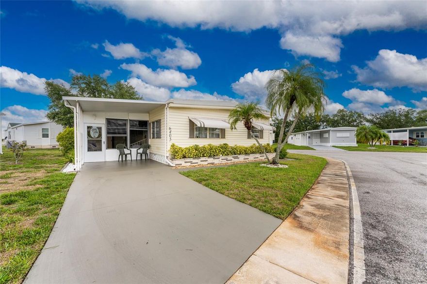 Lovely furnished turnkey, and tasetefully decorated home on a corner lot in Phase II, where pets are allowed. This home features an open floor plan and inside laundry. You are lucky enough to have both a lanai and sunroom. There is laminate flooring in the kitchen/dining areas and luxury vinyl plank in the living room.  Updates include new AC in 24 and a new membrande roof in 22.  Holiday Park and Recreation District is a 55+ deed resticted, gated community.  Unlike most amanufactured home communities in the area, it is a Special District, not an HOA. There are no monthly HOA fees, the Non-Ad Valorem Assestment is due annually on your tax bill.