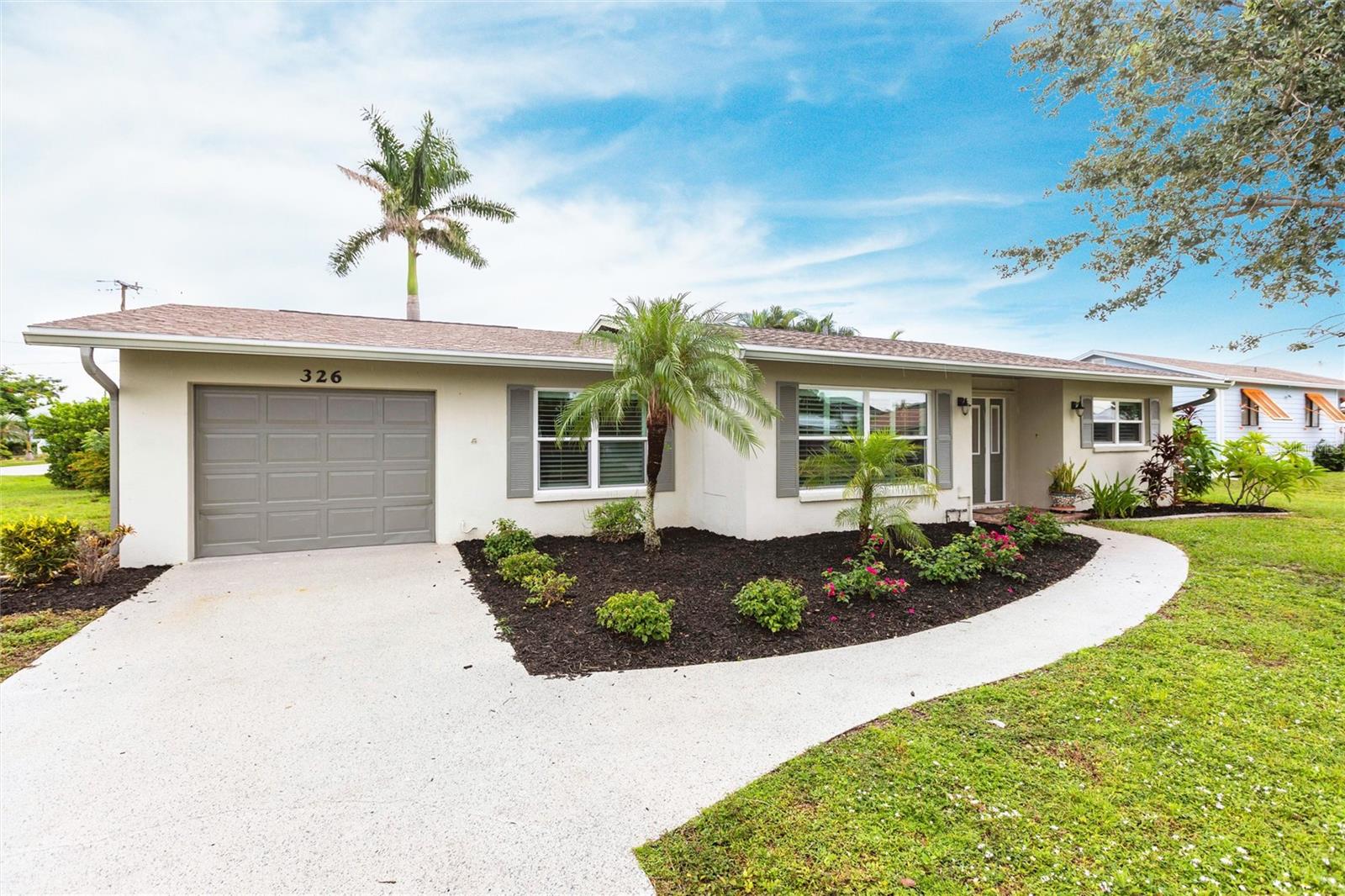 Charming Historic District Home in Punta Gorda! Crisp, clean, and beautifully updated 2025, this 2-bedroom, 2-bath residence on an oversized corner lot seamlessly blends historic character with modern comfort in one of the city’s most desirable neighborhoods. From the moment you arrive, the curb appeal shines with lush tropical landscaping, vibrant flowering plants, and manicured garden beds framed by fresh mulch. A curved walkway leads to the covered entry, where an inviting front door sets the tone. Wide windows with plantation shutters add charm while flooding the home with natural light. The soft, neutral exterior palette with coordinating shutters enhances the timeless design, creating a warm first impression that continues inside. Step through the front door to a bright, open layout where the living room flows into the family room and continues into the updated kitchen—ideal for both relaxation and entertaining. Freshly painted walls and luxury vinyl plank flooring lend a modern touch, while large sliding glass doors extend the living space outdoors for easy indoor-outdoor enjoyment. A versatile dining room can also serve as a home office, den, or hobby room, giving you flexibility to suit your lifestyle. The heart of the home is the stunning kitchen, designed with both style and function in mind. Featuring all-new stainless-steel appliances, abundant cabinetry in a rich modern finish, and elegant marble-look countertops, it offers plenty of space for cooking and entertaining. A large peninsula with sink and seating overlooks the living and family areas, creating a natural hub for gatherings. Recessed lighting highlights the clean lines and open design, while durable wood-look flooring adds warmth and continuity. Two spacious bedrooms serve as peaceful retreats, each filled with natural light and enhanced by plantation shutters, ceiling fans, and stylish wood-look flooring. Custom barn-style sliding closet doors add a touch of charm while maximizing storage. The bathrooms are equally impressive, showcasing marble-look quartz vanities, sleek fixtures, and walk-in showers with elegant tile surrounds and pebble stone floors. A large window in the primary bath brightens the space, while the finishes tie seamlessly into the home’s modern yet timeless style. Additional highlights include a large laundry/utility room, attached one-car garage, backyard storage shed, new A/C (2025), updated plumbing (2025), and a shingle roof (2022). Home did experience flooding from a past hurricane and has since been thoughtfully renovated, offering peace of mind with modern updates throughout. Located in the heart of downtown Punta Gorda, the home is within walking or biking distance to shops, restaurants, galleries, walking trails, parks, Laishley Marina, Fishermen’s Village, and more. This is truly a must-see home combining history, charm, and modern convenience! **PLEASE ENJOY THE 3D INTERACTIVE VIRTUAL TOUR ASSOCIATED WITH THIS LISTING**