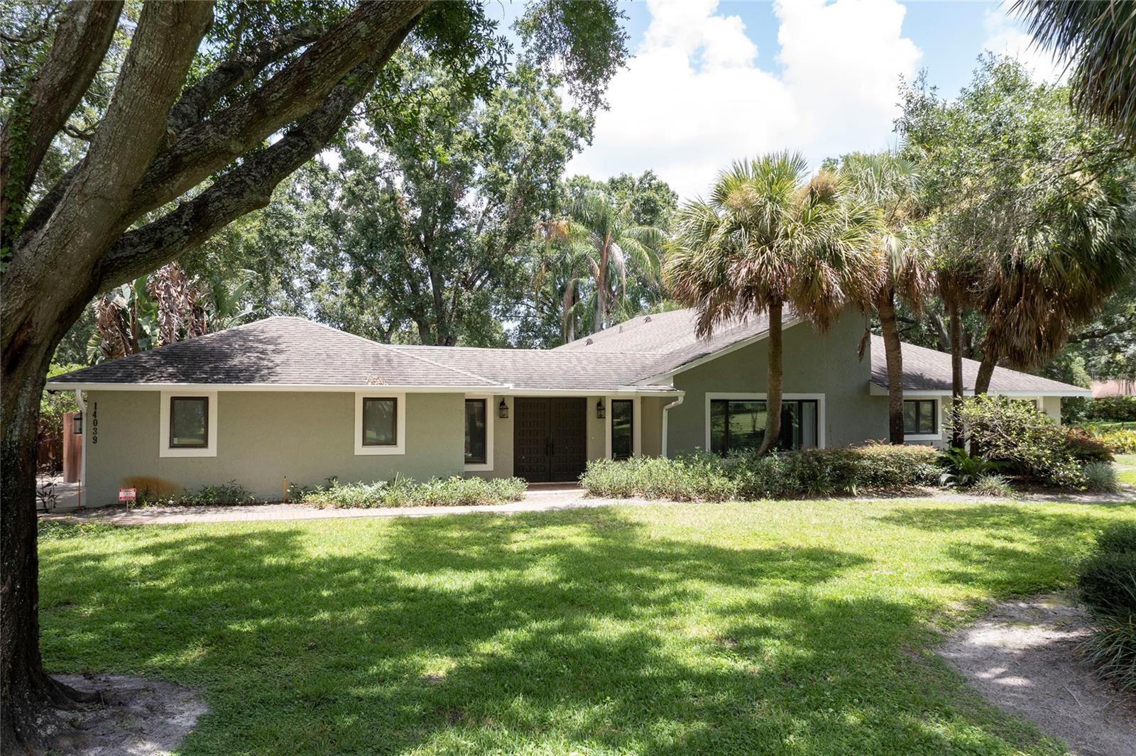 Escape the hustle without sacrificing convenience in this 3 bedroom 3 bathroom 2018 SF single story retreat nestled on a one-acre corner lot in the exclusive Country Lakes Estates community of Winter Garden. This home strikes the perfect balance between peaceful country living and urban accessibility. The family room centers around an impressive 14 ft stone fireplace with matching built-ins on either side that provide storage and display space. The kitchen caters to both busy weeknight dinners and weekend entertaining with granite countertops, stainless steel appliances, and an 8-foot breakfast bar perfect for casual dining. Step outside to your own private oasis featuring a screen-enclosed pool and a generous 20x8 covered brick paver lanai where you can unwind after long workdays or host memorable gatherings. The location offers unparalleled convenience with Winter Garden Village's shopping and dining just 5 minutes away, charming downtown Winter Garden a quick 10-minute drive, and downtown Orlando accessible in just 25 minutes via easy connections to the 429 and Turnpike. As a resident, you'll enjoy exclusive access to the community's tennis courts and private boat ramp leading to Lake Tilden and Black Lake, adding a recreational element that's rare to find so close to the city. This is more than just a home—it's a lifestyle upgrade that provides the space and tranquility you crave while keeping you connected to everything that matters. Properties in this coveted pocket community rarely become available, making this your chance to secure a slice of paradise that offers the best of both worlds.
