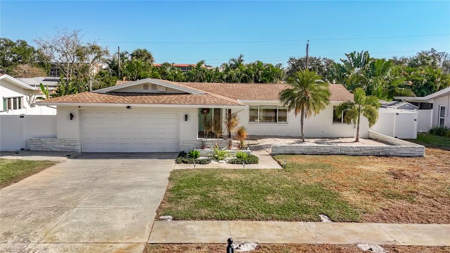 Located in the highly sought-after Yacht Club Estates, this spacious and beautifully updated 4-bedroom, 2-bathroom home offers the perfect blend of comfort, style, and Florida living. The heart of the home features an open floor plan connecting the living room, kitchen, and dining area. The living room accommodates a large sectional and overlooks the charming front courtyard through multiple windows, filling the space with natural light.

The chef’s kitchen is equipped with abundant cabinetry, gorgeous quartz countertops, and both an island and peninsula finished with elegant waterfall edges, providing bar seating ideal for everyday meals or entertaining. A dry bar with additional cabinetry, shelving, and a wine fridge adds a luxurious touch. The dining area sits just off the kitchen, offering an intimate atmosphere with sliding glass doors that open directly to the backyard.

The primary suite, privately situated on the right side of the home, is generous in size and filled with natural light. Its en-suite bath includes a double vanity, a glass-panel walk-in shower, and a large walk-in closet. On the opposite side of the home are three guest bedrooms and an oversized guest bath featuring a double vanity, tiled European-style shower, and a separate bathtub. One of the guest bedrooms enjoys direct access to this bath, creating a comfortable second-suite feel. The remaining two guest bedrooms, set toward the back of the home, are perfect for quiet home office spaces.

Outside, enjoy the newly installed paver patio and beautiful back porch, ideal for relaxing or entertaining. The home also boasts new plumbing throughout, a 2-car garage, and is positioned on a peaceful street just under 5 minutes from the white sand beaches of the Gulf of Mexico. Close to shops, restaurants, and surrounded by tree-lined sidewalks perfect for biking and jogging, this home embodies the best of Florida living while maintaining a sense of calm and privacy.