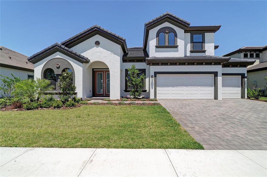 One or more photo(s) has been virtually staged. Key Largo II - 
This Key Largo II home is Ready Now! presents a rare chance to own a designer-upgraded residence within the nearly completed, gated community of Hidden Lakes in Brandon, FL. Step inside and discover a home designed for both comfort and grand entertaining. The kitchen is fully upgraded with gourmet-style appliances, Maddox Painted Harbor cabinets, and elegant Frost Whte MSI Quartz countertops, all complemented by Home Nutmeg LVP flooring. The two-story floor plan features soaring 12-foot ceilings throughout the foyer, formal dining room, grand room, and kitchen, creating a dramatic and open layout. You'll find large sliding glass doors in the grand room that invite natural light, along with beautiful wood ceiling beams that add a touch of elegance. The downstairs owner's retreat offers a private sanctuary, complete with a double door entry, two spacious walk-in closets, and a dedicated dressing area. The generous primary bathroom is a spa-like escape, featuring a freestanding tub and luxury finishes. This home also provides ample space with spacious secondary bedrooms, an upstairs bonus room, an oversized laundry/hobby room, and a fantastic outdoor living area with a covered lanai, perfect for relaxation or gatherings. The exterior boasts enhanced curb appeal thanks to elegant stonework on the front elevation. Hidden Lakes itself offers a desirable living experience, featuring well-designed floorplans. All homes in this community come standard with durable tile roofs, attractive paver driveways, and spacious 75-foot wide homesites. Don't miss this opportunity to own a meticulously designed home in a thriving Brandon community.
Images shown are for illustrative purposes only and may differ from actual home. Exterior image shown for illustrative purposes only and may differ from actual home. Completion date subject to change.