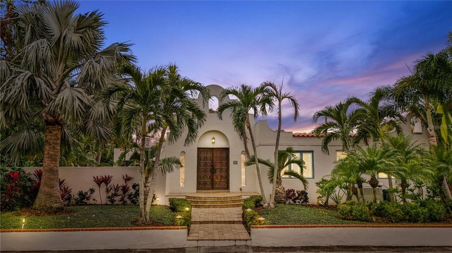 Mediterranean compound estate double lot in historic Old Northeast! On a commanding corner lot in St. Petersburg’s desired historic Old Northeast, this Mediterranean-inspired compound estate offers a rare blend of architectural distinction, sustainable systems and multi-residence flexibility. Renovated by award-winning Strobel Design Build, the three-bedroom, two-bath primary residence showcases custom design features including bespoke metal arched double-opening doors and handcrafted windows that frame the estate’s lushly landscaped grounds. All on .28 acres, 93x131. Solar panels—owned outright—support energy efficiency, while natural gas services the gourmet kitchen and Aqua Lounge fireplace. A seamless indoor-outdoor connection flows from the open-concept interiors to a screened lounge, where gas fire and ceiling fans enable all-season entertaining. Beyond lies a travertine pool deck and a saltwater pool with integrated Fastlane Pro system for lap training or leisure. Designed for privacy and versatility, this gated compound is further enhanced by The Annex, a two-bedroom, one-bath guesthouse—ideal for guests, extended family or income generation, The Nest, a detached one-bedroom, one-bath garage apartment with private entry. Four power meters, offering zoning flexibility for future development or estate planning. A caged shed for the ideal vegetable garden or orchids. Concealed behind layered landscaping and architectural hardscapes, the property provides a resort-style experience in a private estate setting—in this desired neighborhood, all just moments from waterfront parks, fine dining and St. Petersburg’s Beach Drive district.